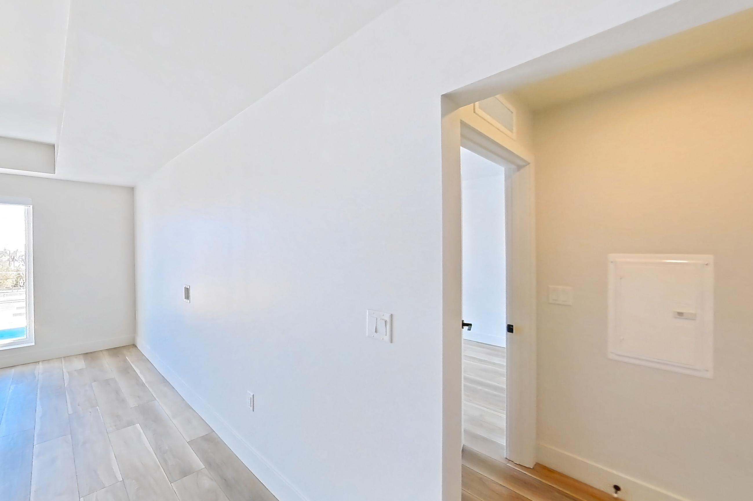 Living room with light wood-finish flooring and wood-look tile flooring, Apartment 530 at The Myles