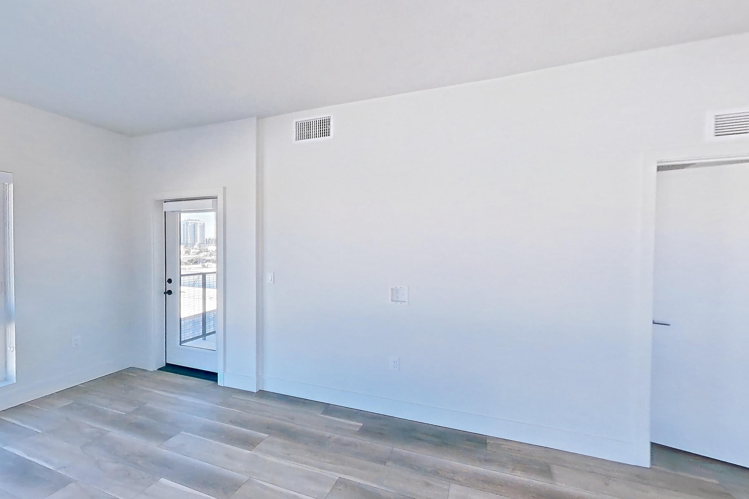 Living room with light wood-finish flooring, Apartment 549 at The Myles