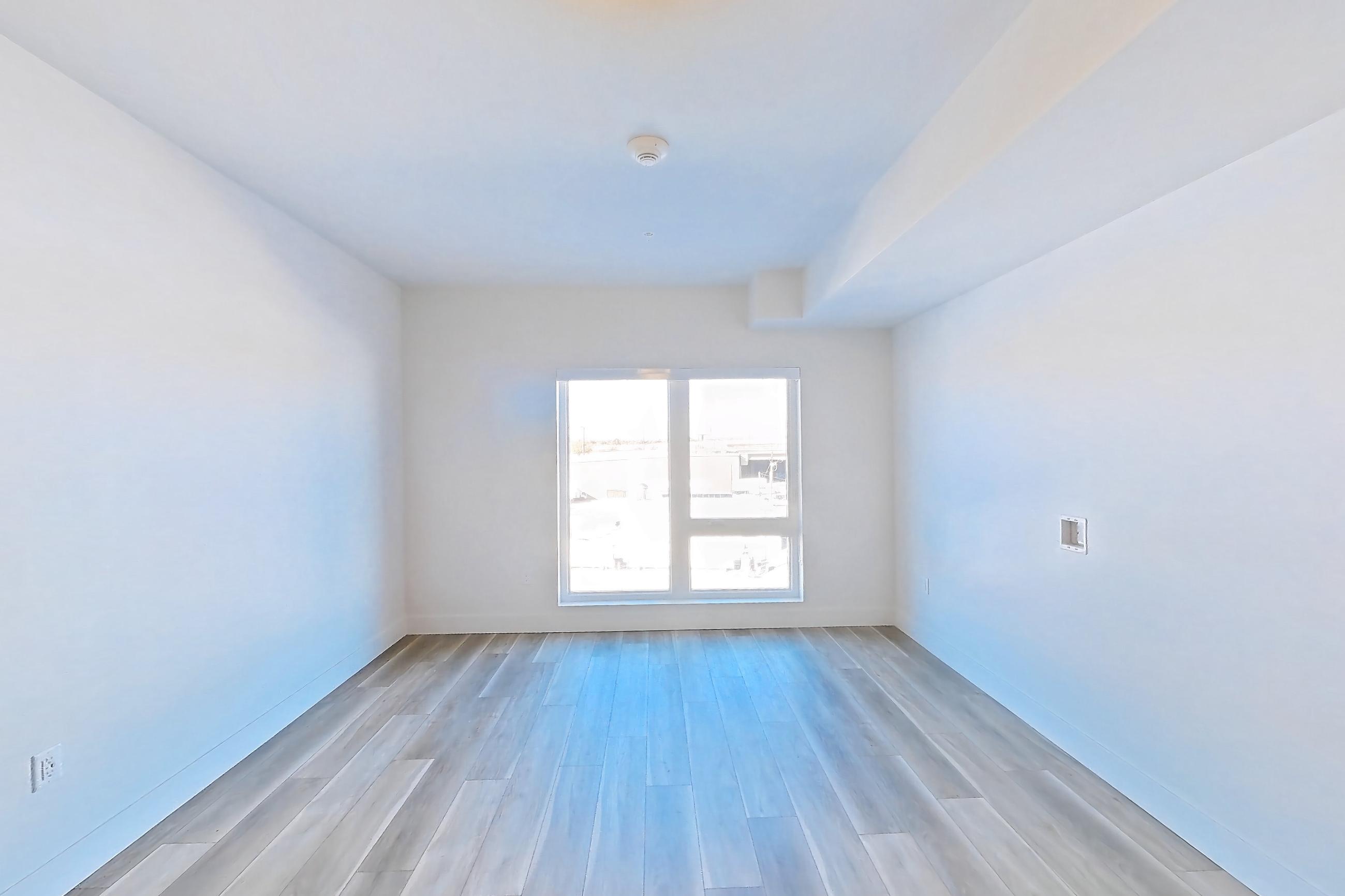 Living room with light wood-finish flooring, Apartment 550 at The Myles