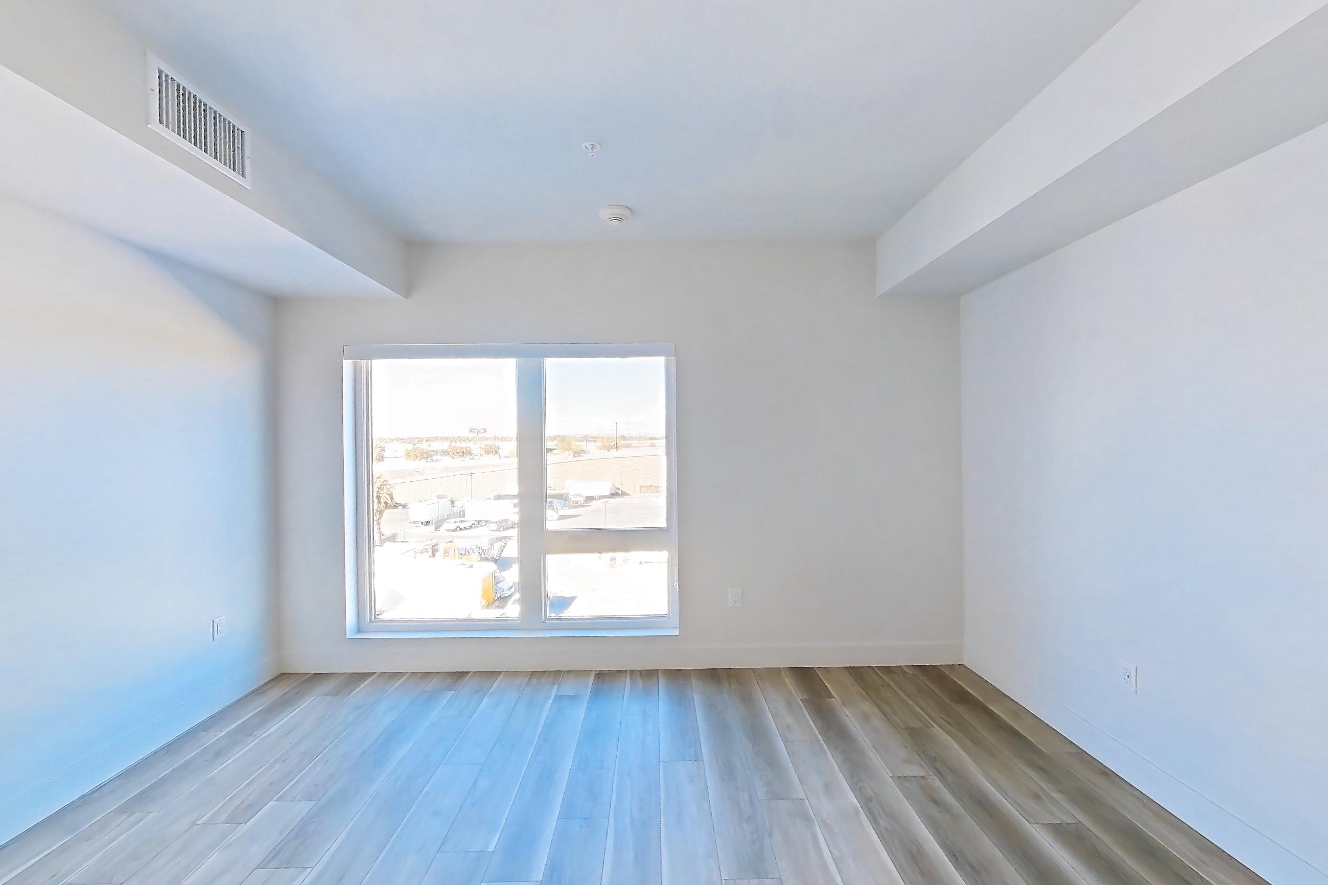 Living space with light wood-finish flooring, Apartment 551 at The Myles