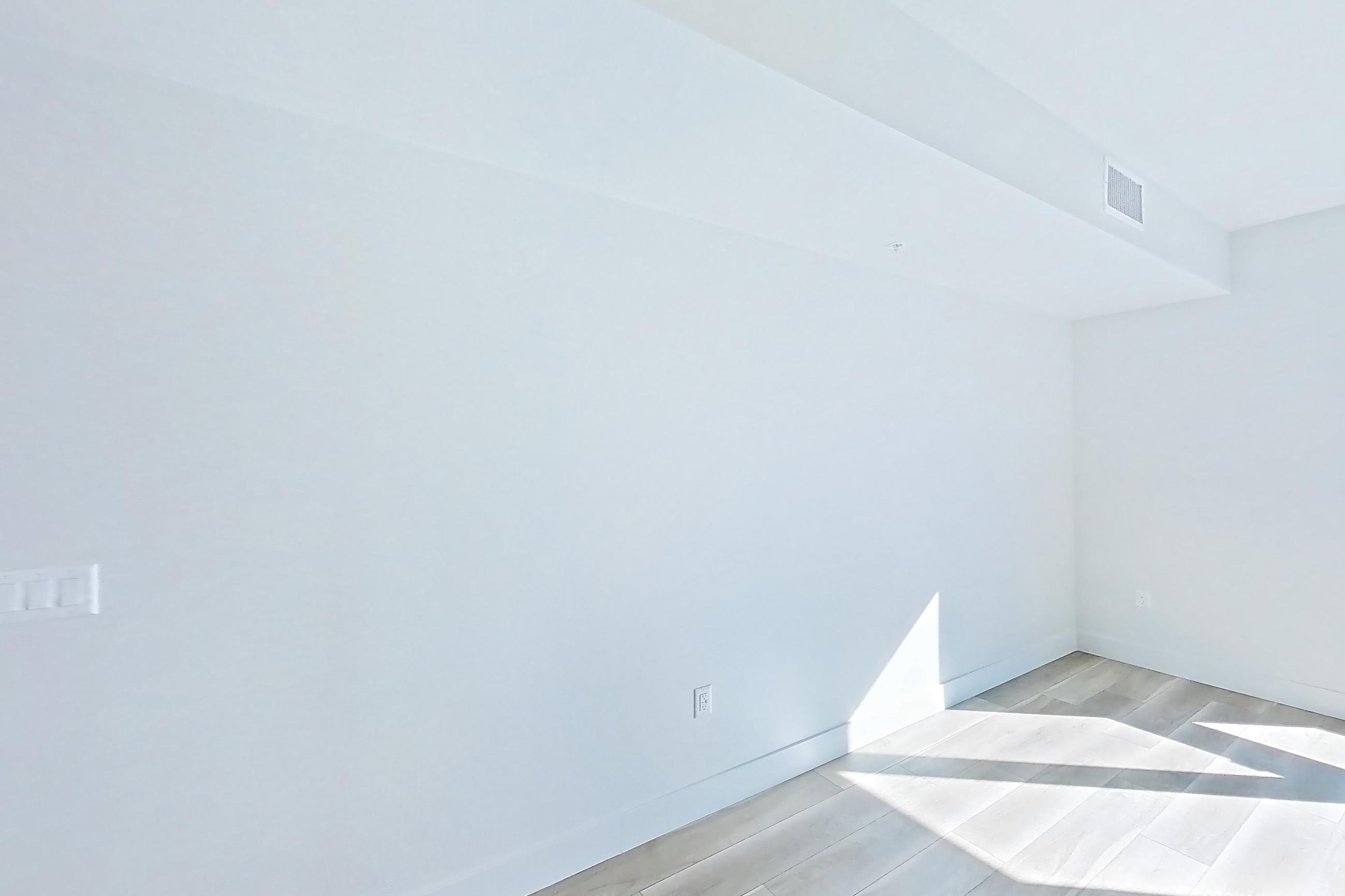Living room with wood-look tile flooring, Apartment 552 at The Myles