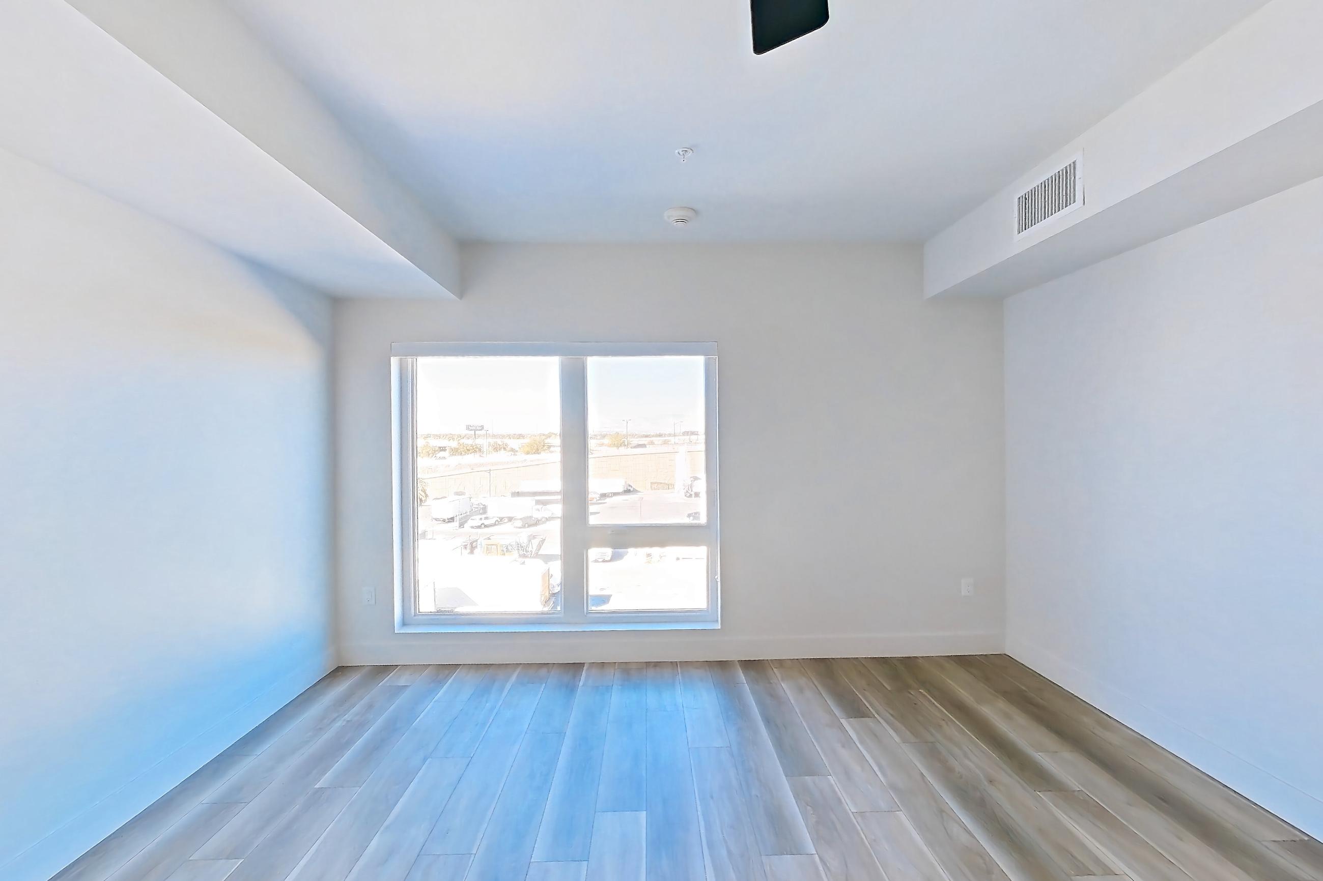 Living space with light wood-finish flooring, Apartment 553 at The Myles