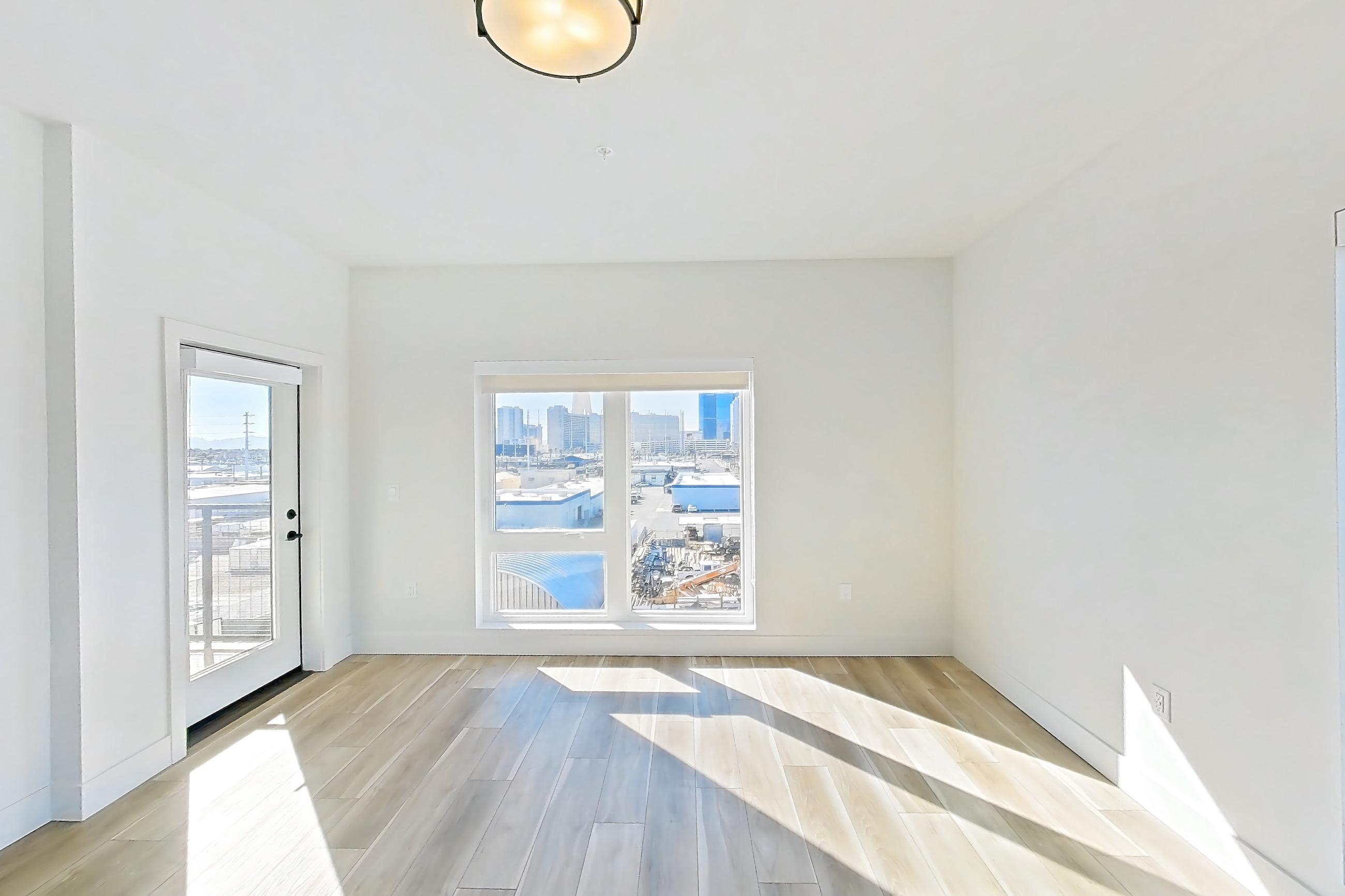 Living room with light wood-finish flooring and wood-look tile flooring, Apartment 556 at The Myles