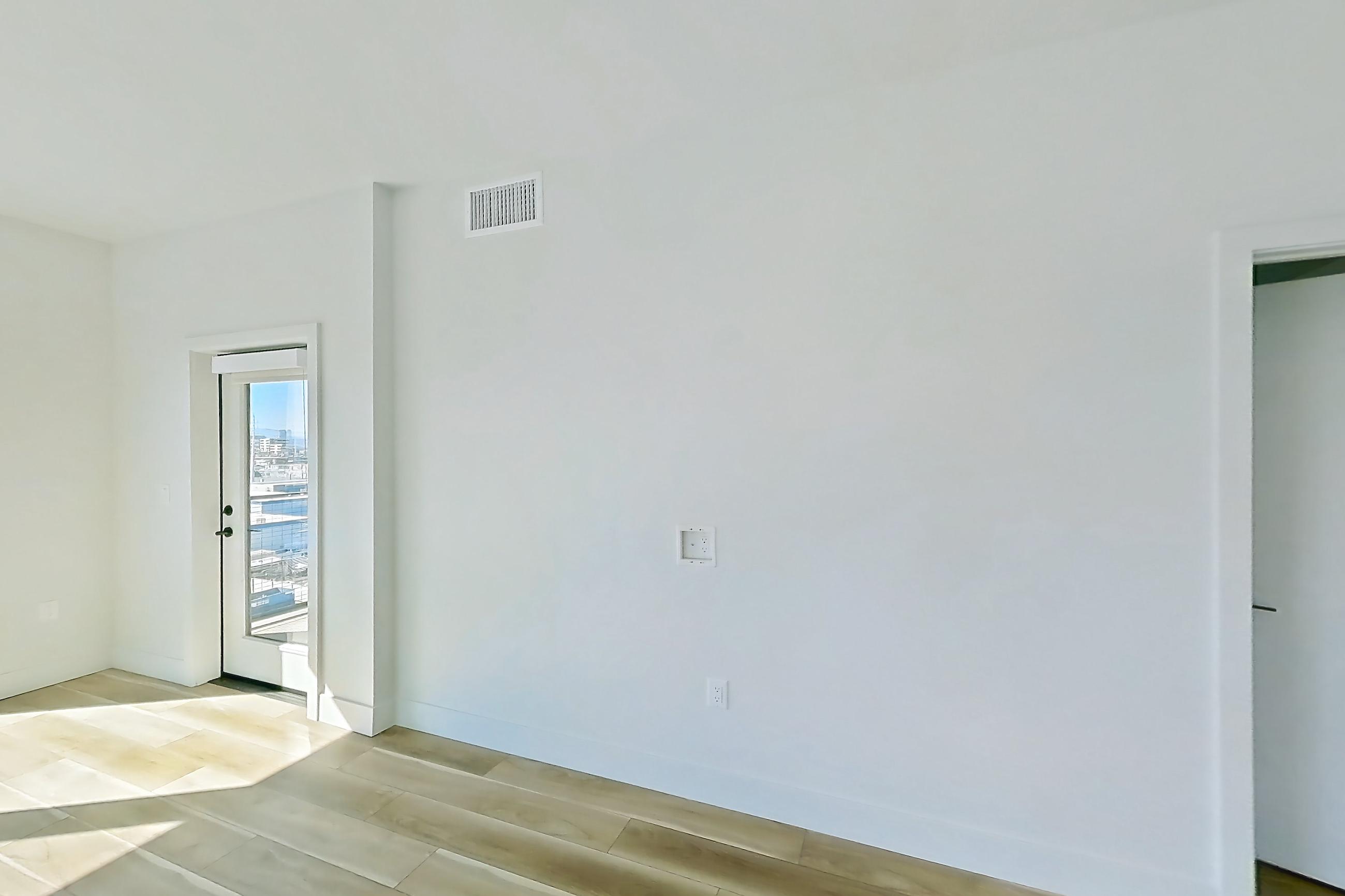 Living room with light wood-finish flooring and wood-look tile flooring, Apartment 605 at The Myles