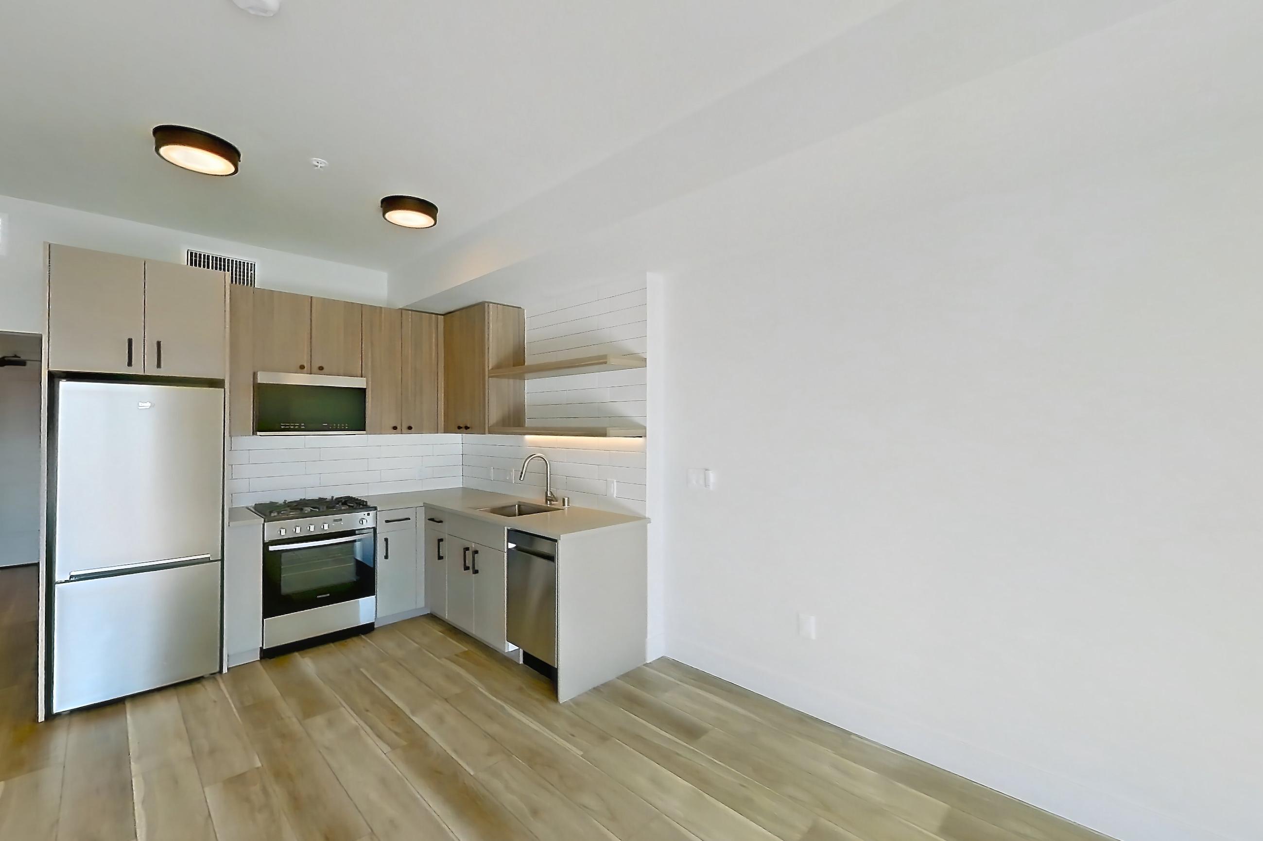 Living space with light wood-finish flooring, Apartment 628 at The Myles