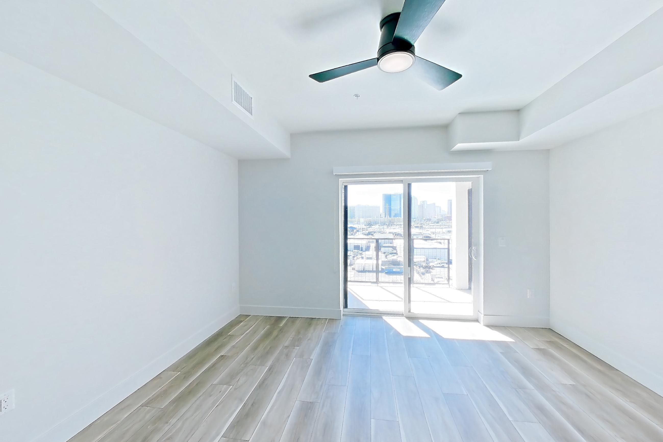 Living space with light wood-finish flooring, Apartment 638 at The Myles