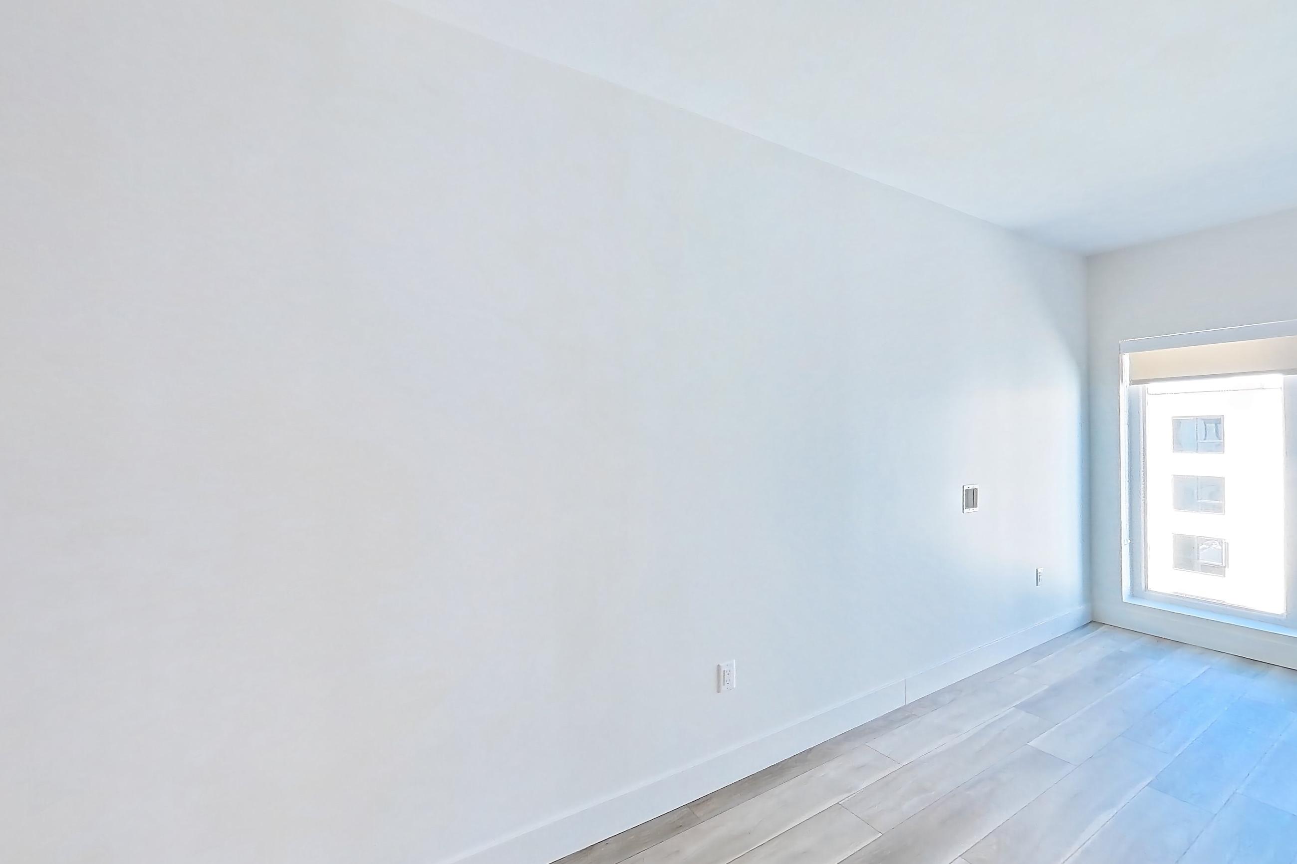 Living room with light wood-finish flooring and wood-look tile flooring, Apartment 702 at The Myles