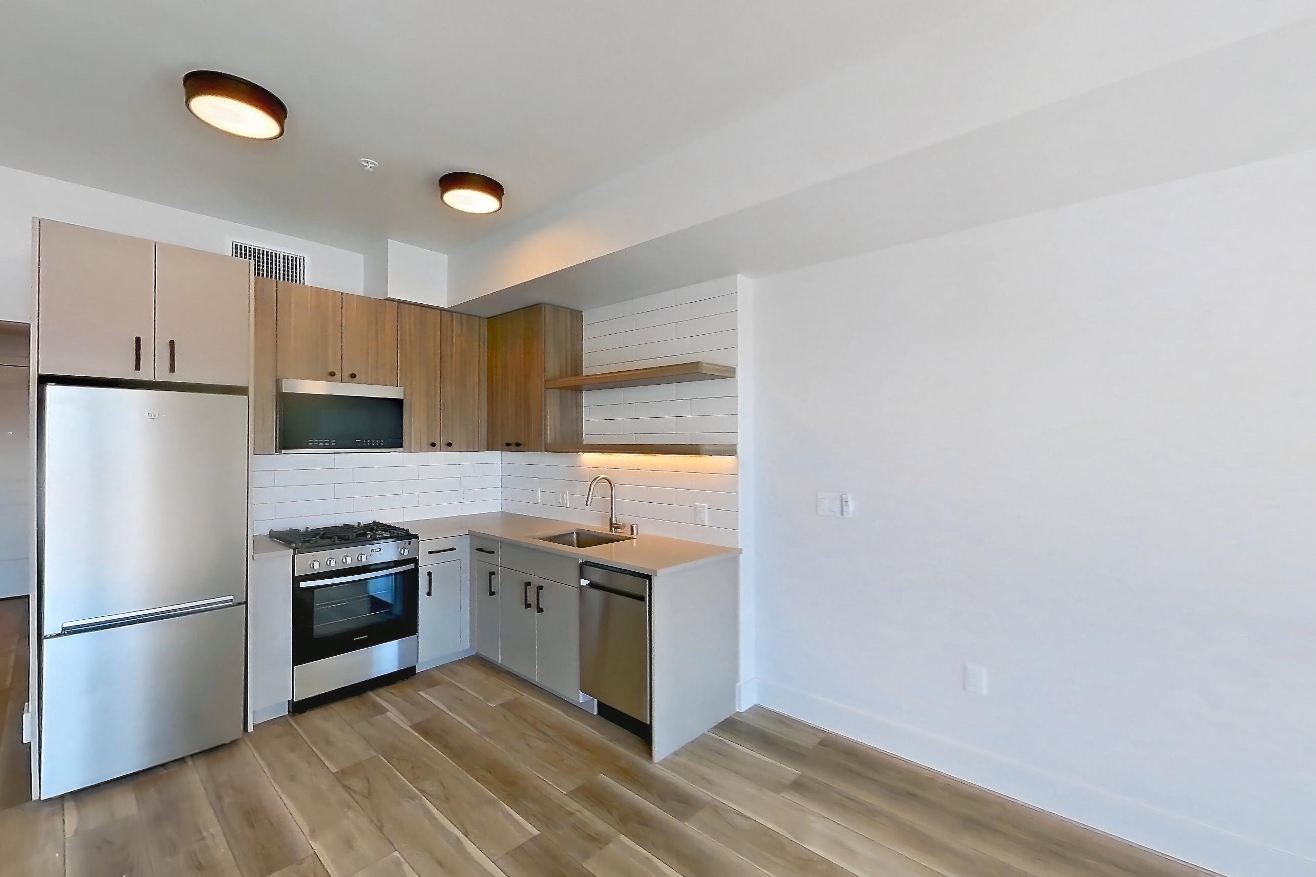 Living space with light wood-finish flooring, Apartment 728 at The Myles