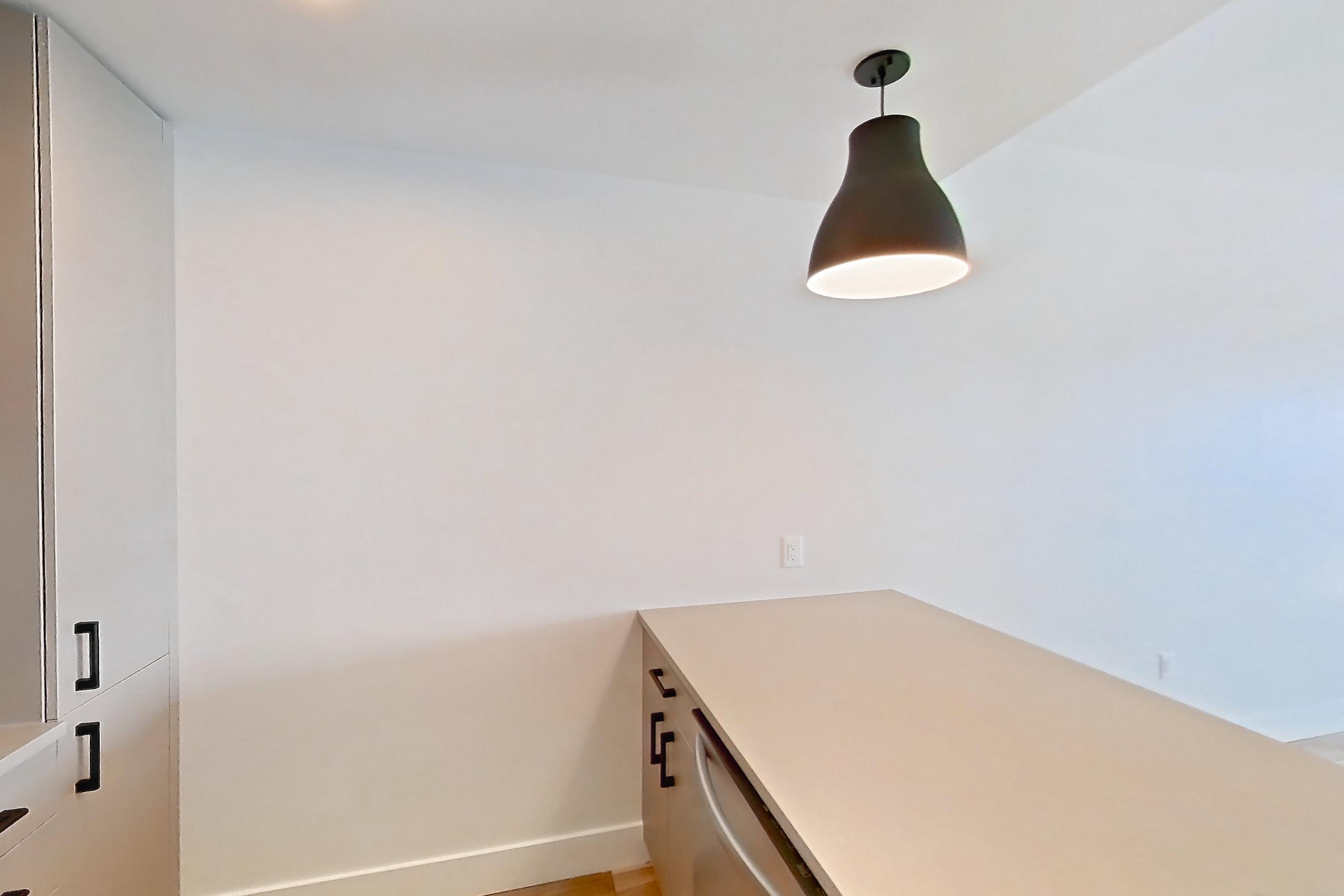 Kitchen with dishwasher, gas range, light countertops, light wood-finish flooring, oven/range, refrigerator, and stainless steel appliances, Apartment 730 at The Myles