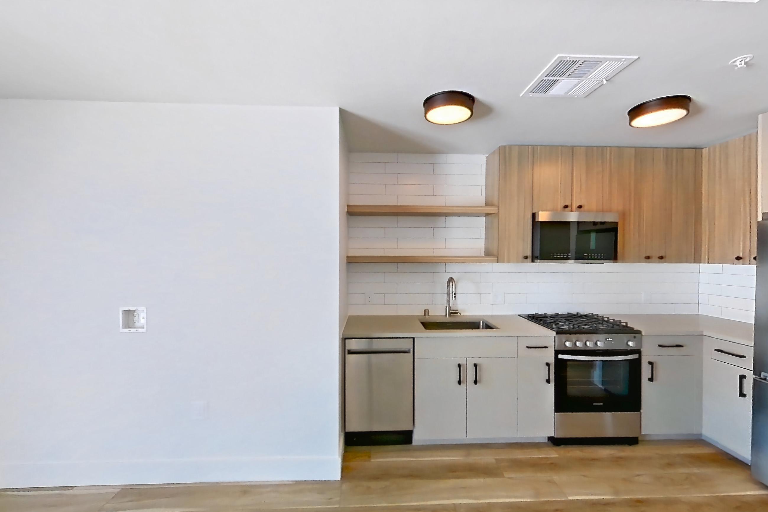 Living space with light wood-finish flooring, Apartment 743 at The Myles