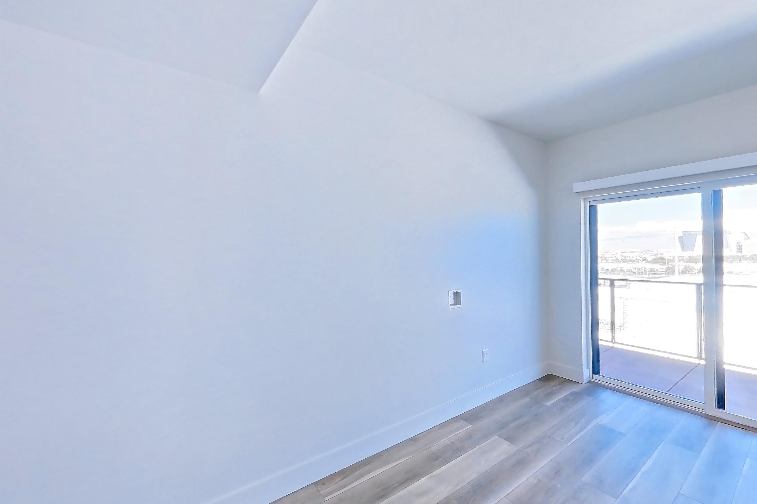 Living room with light wood-finish flooring, Apartment 747 at The Myles