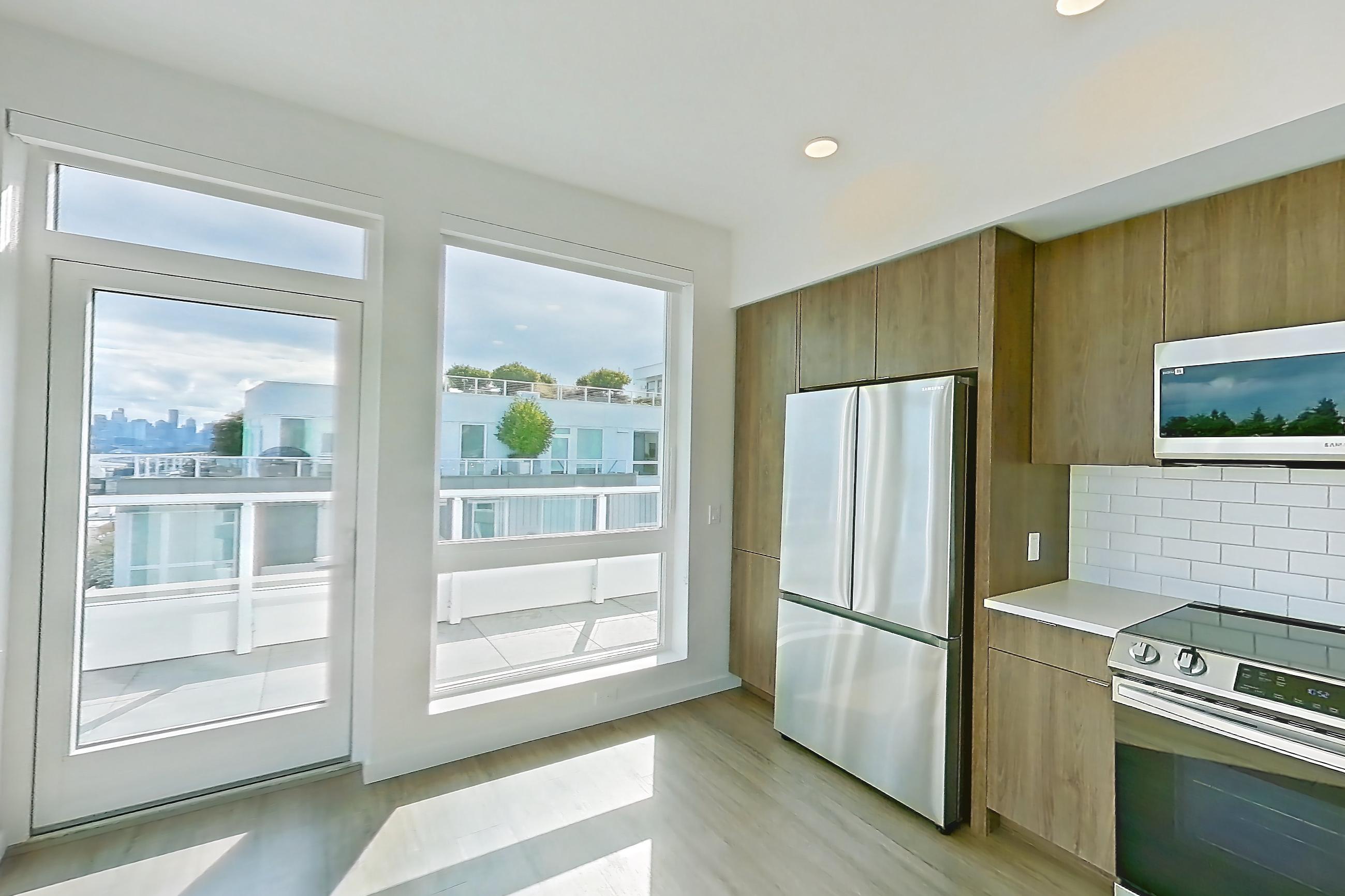 Living room with mini-split AC and refrigerator, Apartment 835 at The Cline