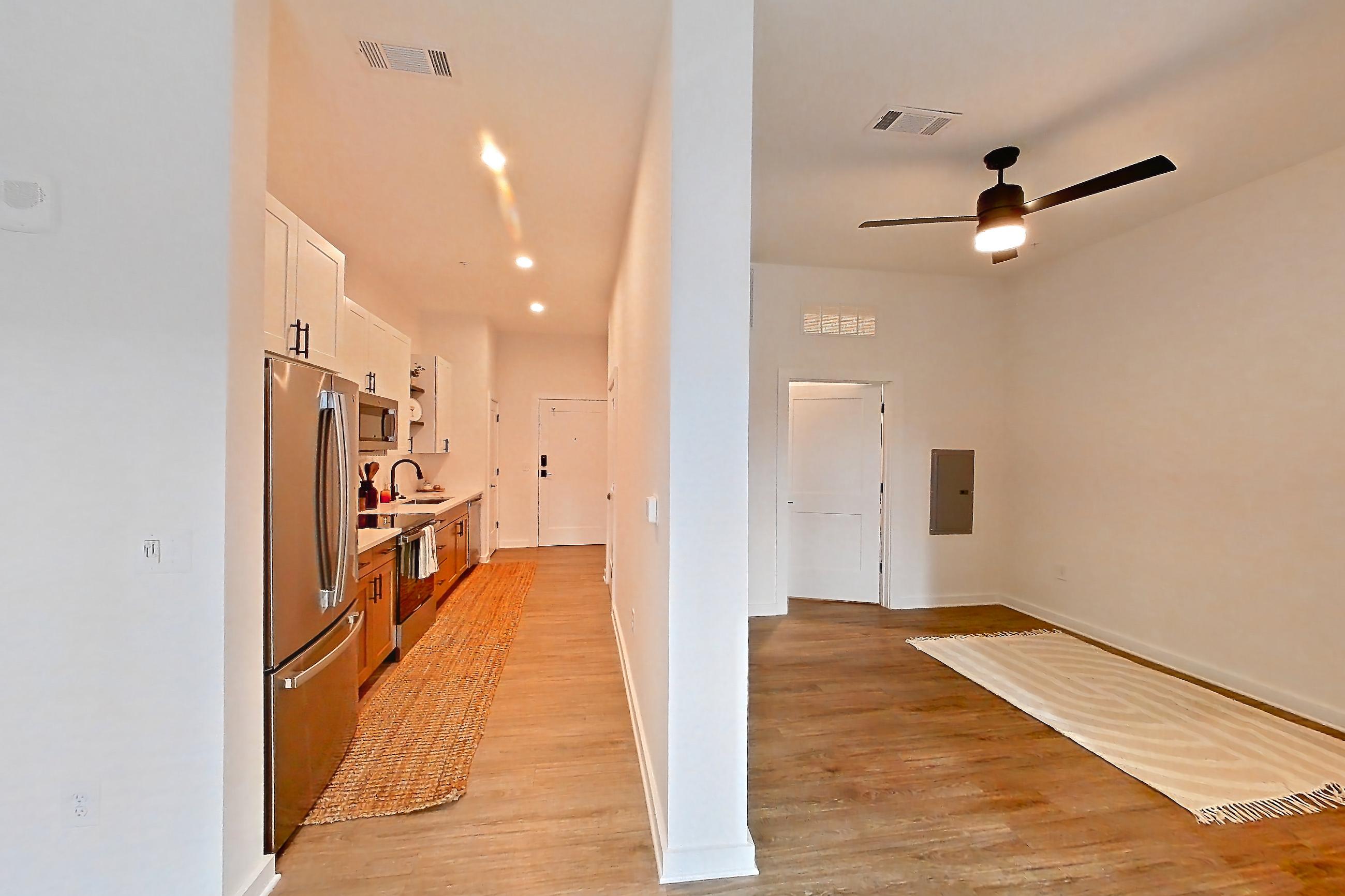 Living space with electric range, oven/range, refrigerator, and stainless steel appliances, Apartment 334 at The Rowe at Commonwealth