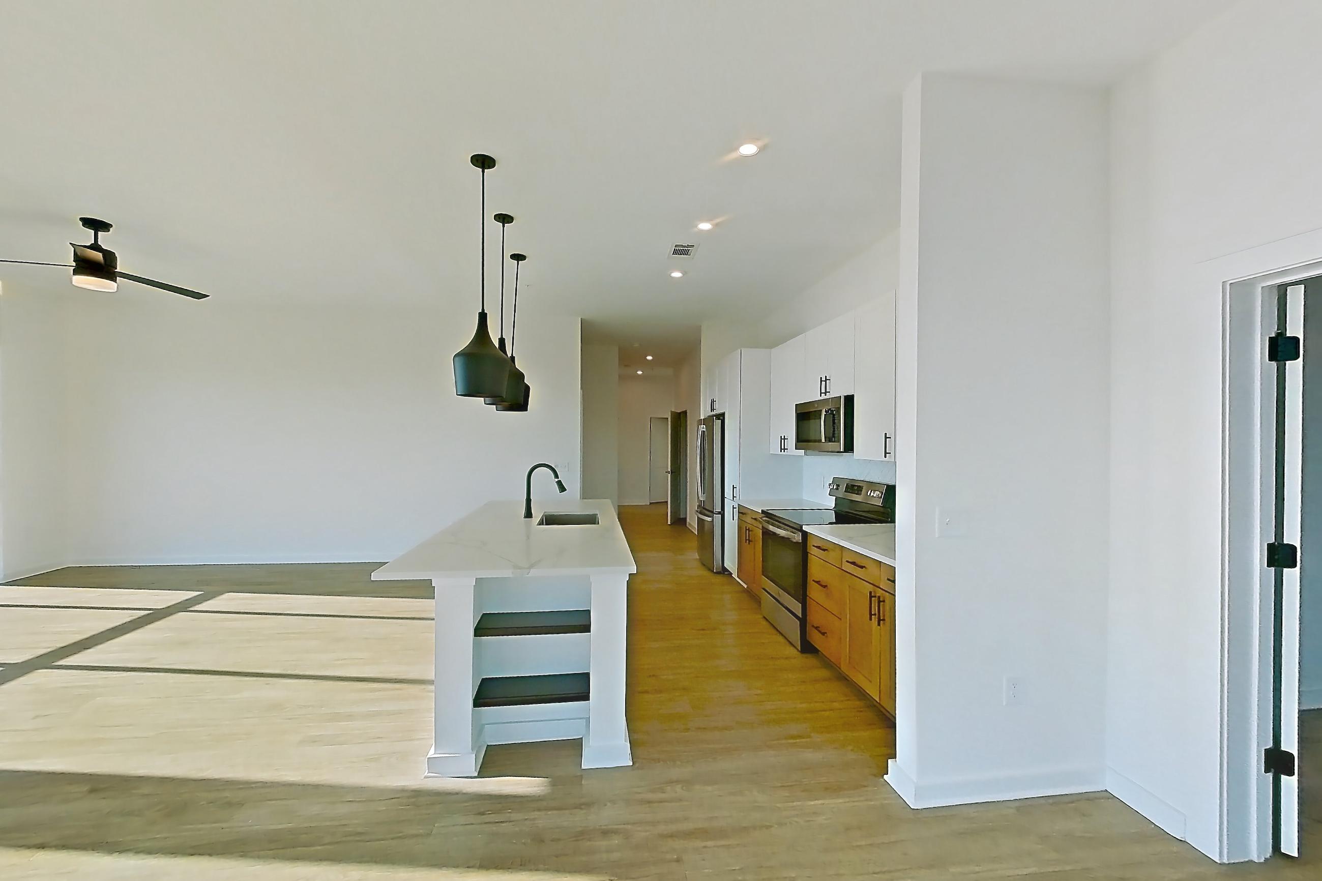 Dining room with electric range, light countertops, oven/range, refrigerator, and stainless steel appliances, Apartment 758 at The Rowe at Commonwealth