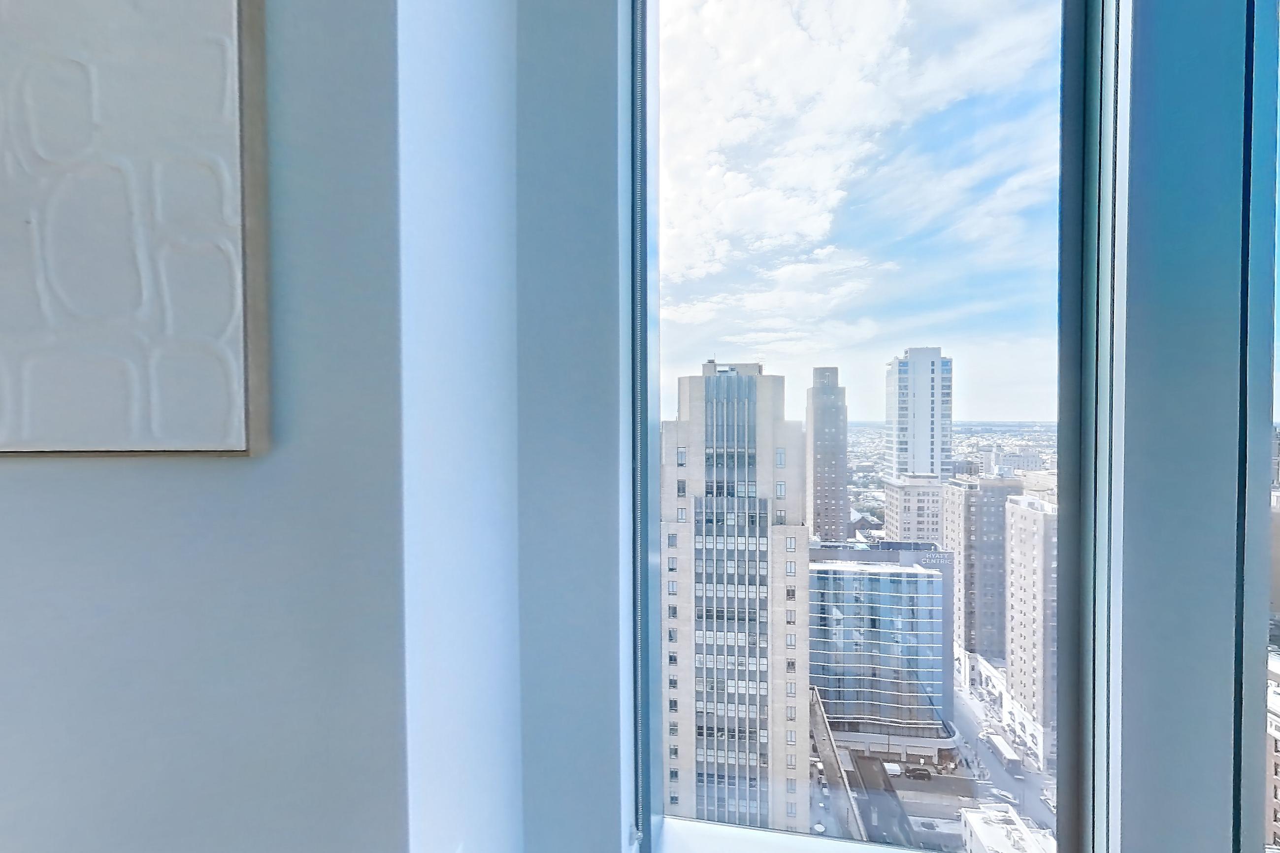 Living room view with light wood-finish flooring, Apartment 2601 at Josephine