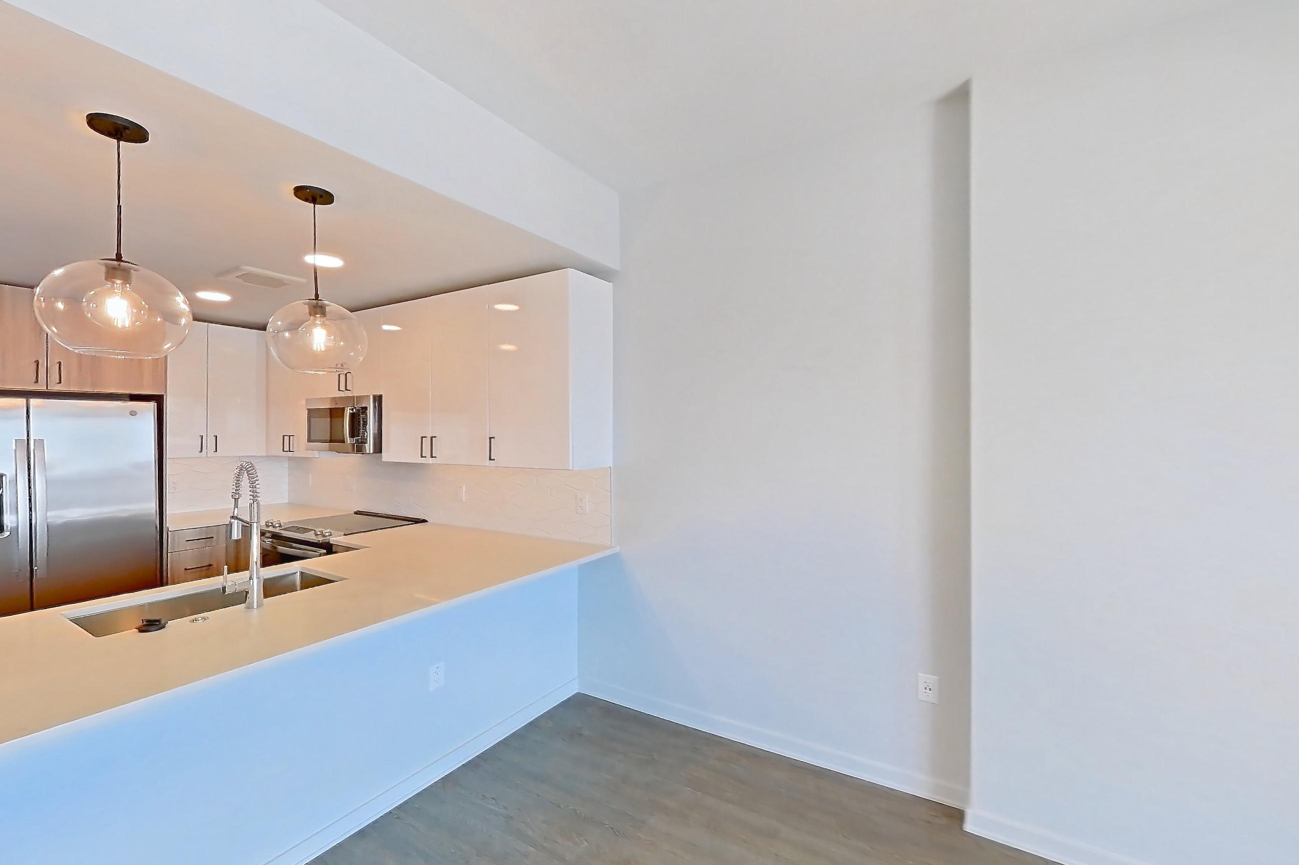 Living room with dark wood-finish flooring, Apartment 1910 at Deco 969