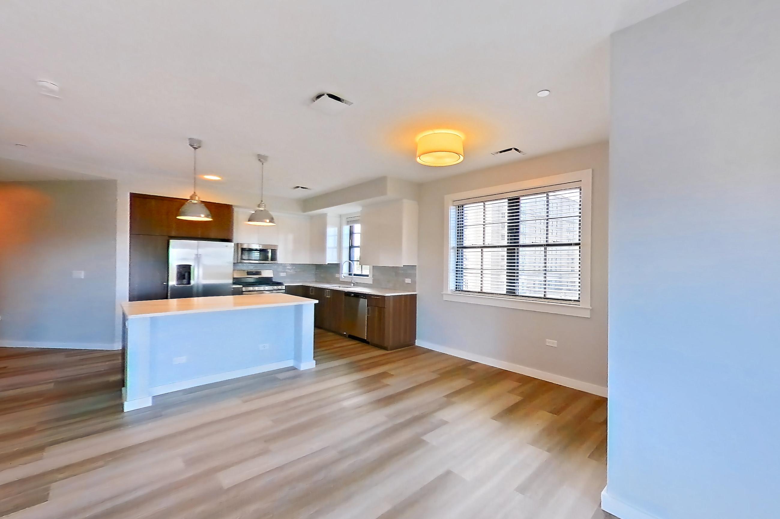 Living space with dishwasher, gas range, light countertops, light wood-finish flooring, oven/range, and stainless steel appliances, Apartment N416 at Carlow Wind Watch