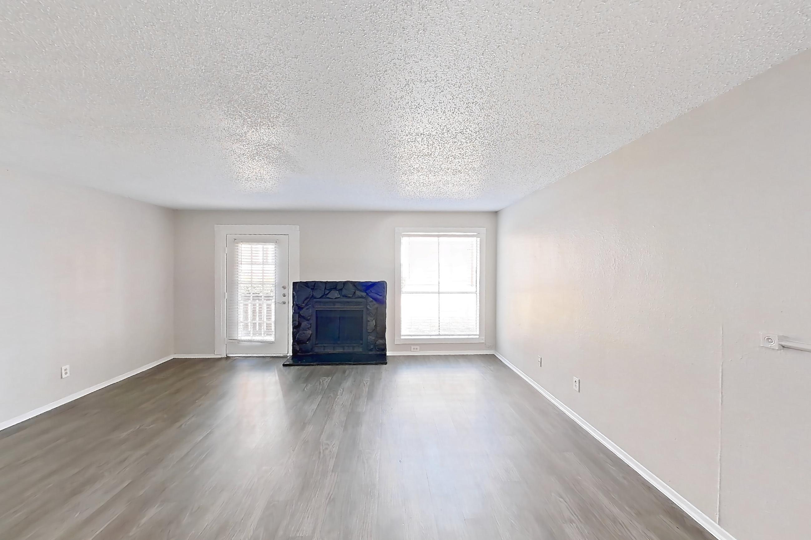 Dining room with dark wood-finish flooring and fireplace, Apartment 1113 at Marine Creek Apartments