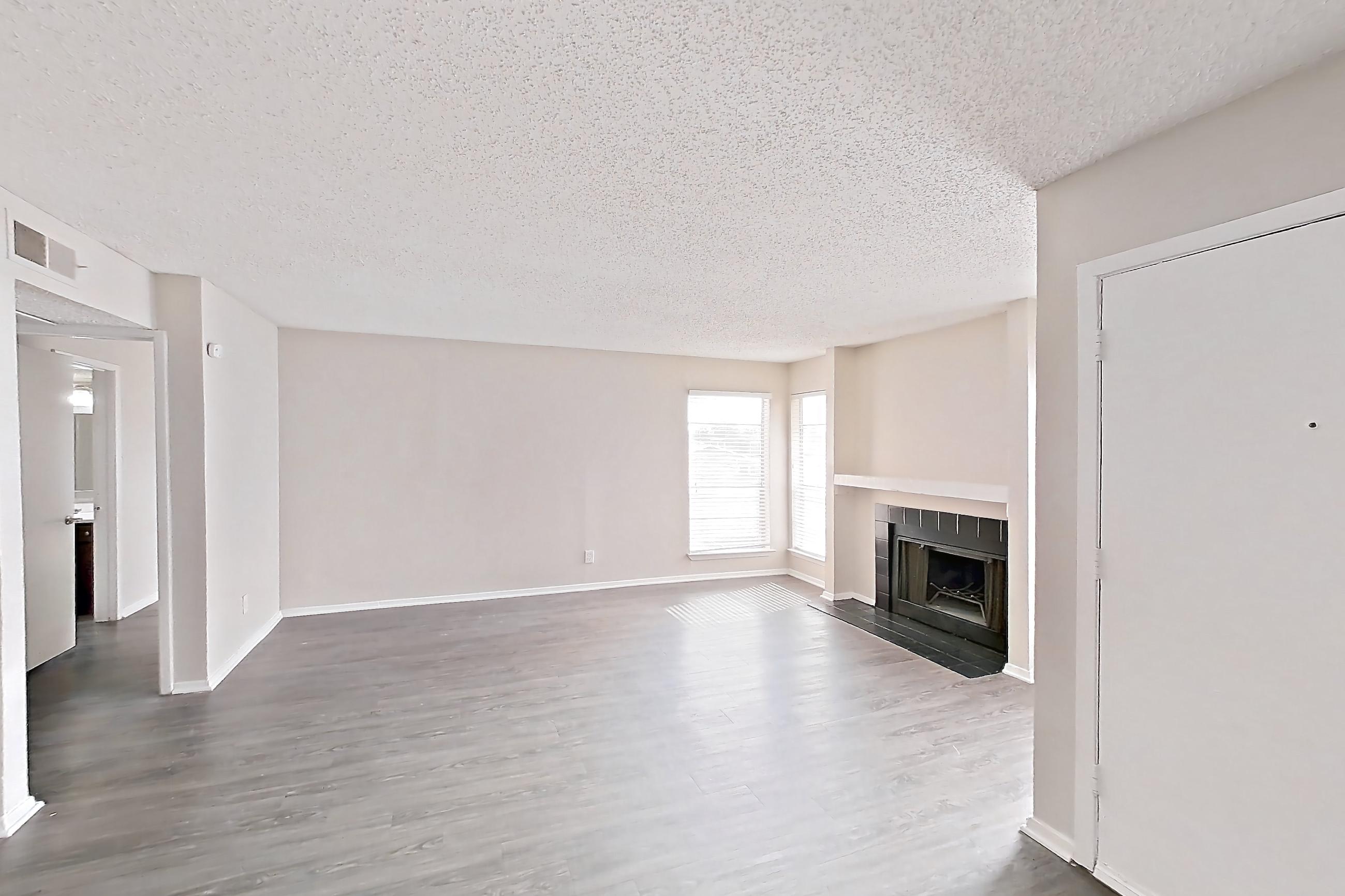 Dining room with dark wood-finish flooring, fireplace, and tile fireplace, Apartment 2825SC at The Cassidy at Western Hills