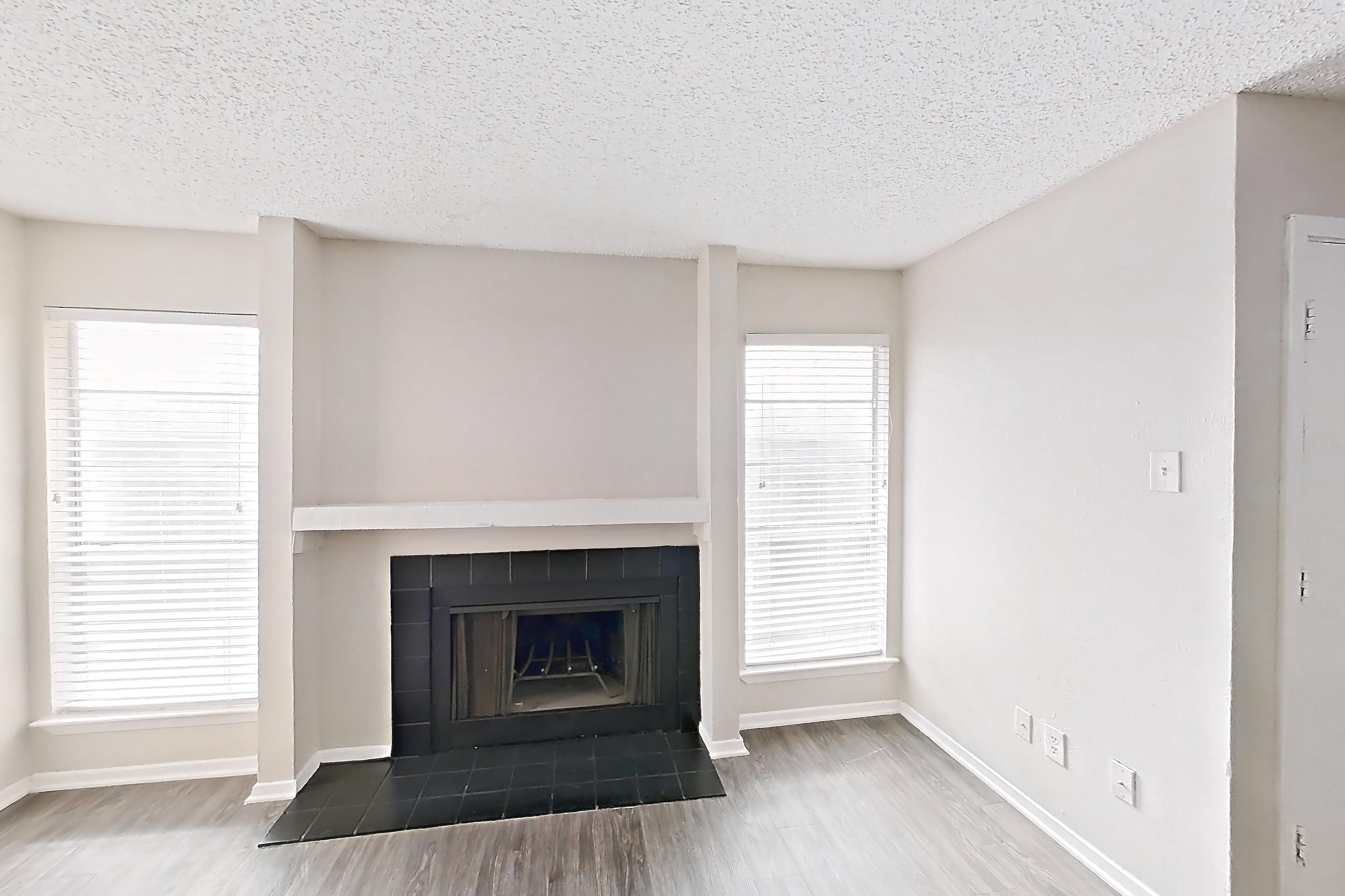 Living room with dark wood-finish flooring, fireplace, and tile fireplace, Apartment 2825SC at The Cassidy at Western Hills