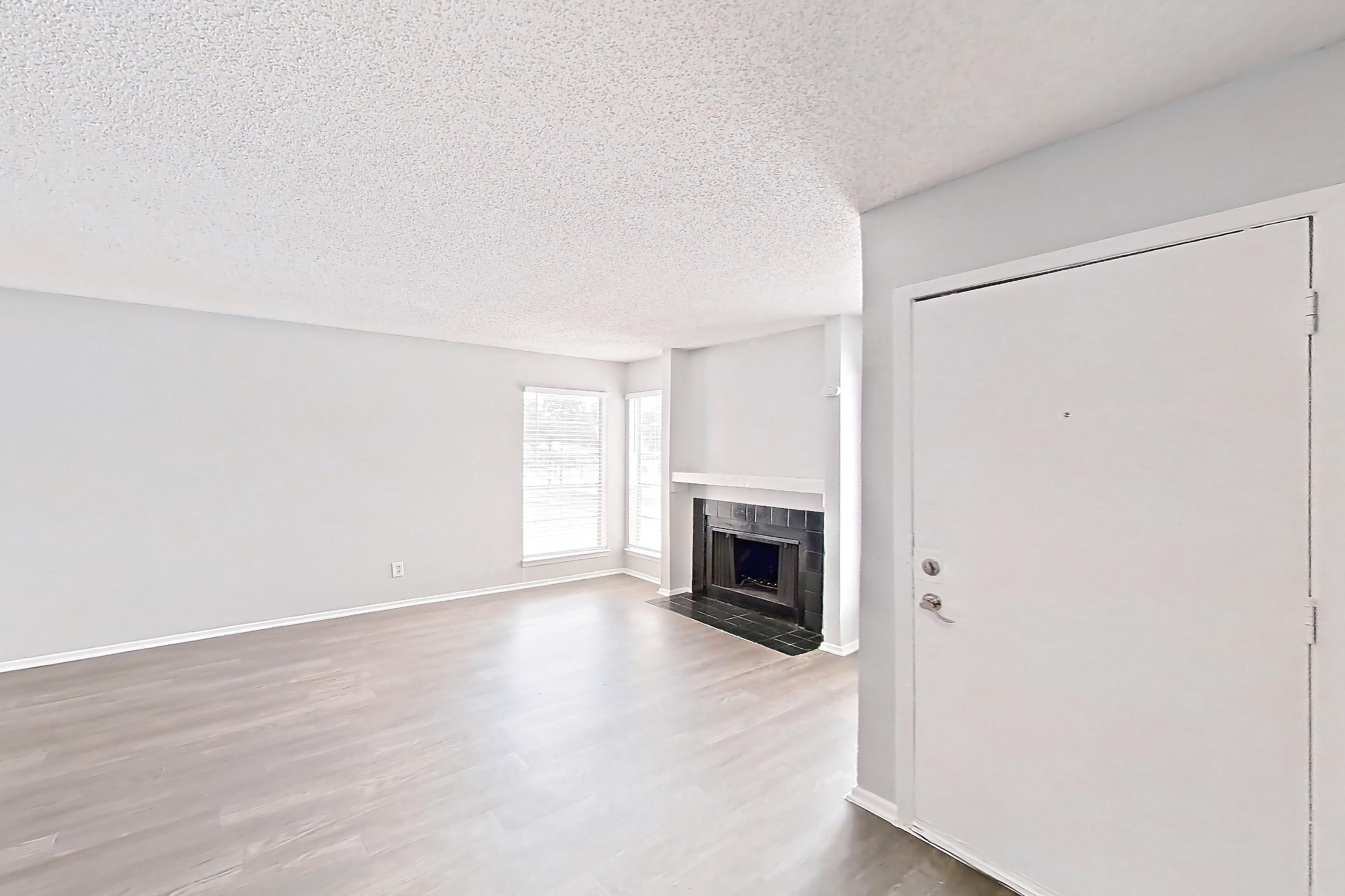 Dining room with dark wood-finish flooring, fireplace, and tile fireplace, Apartment 8930SD at The Cassidy at Western Hills