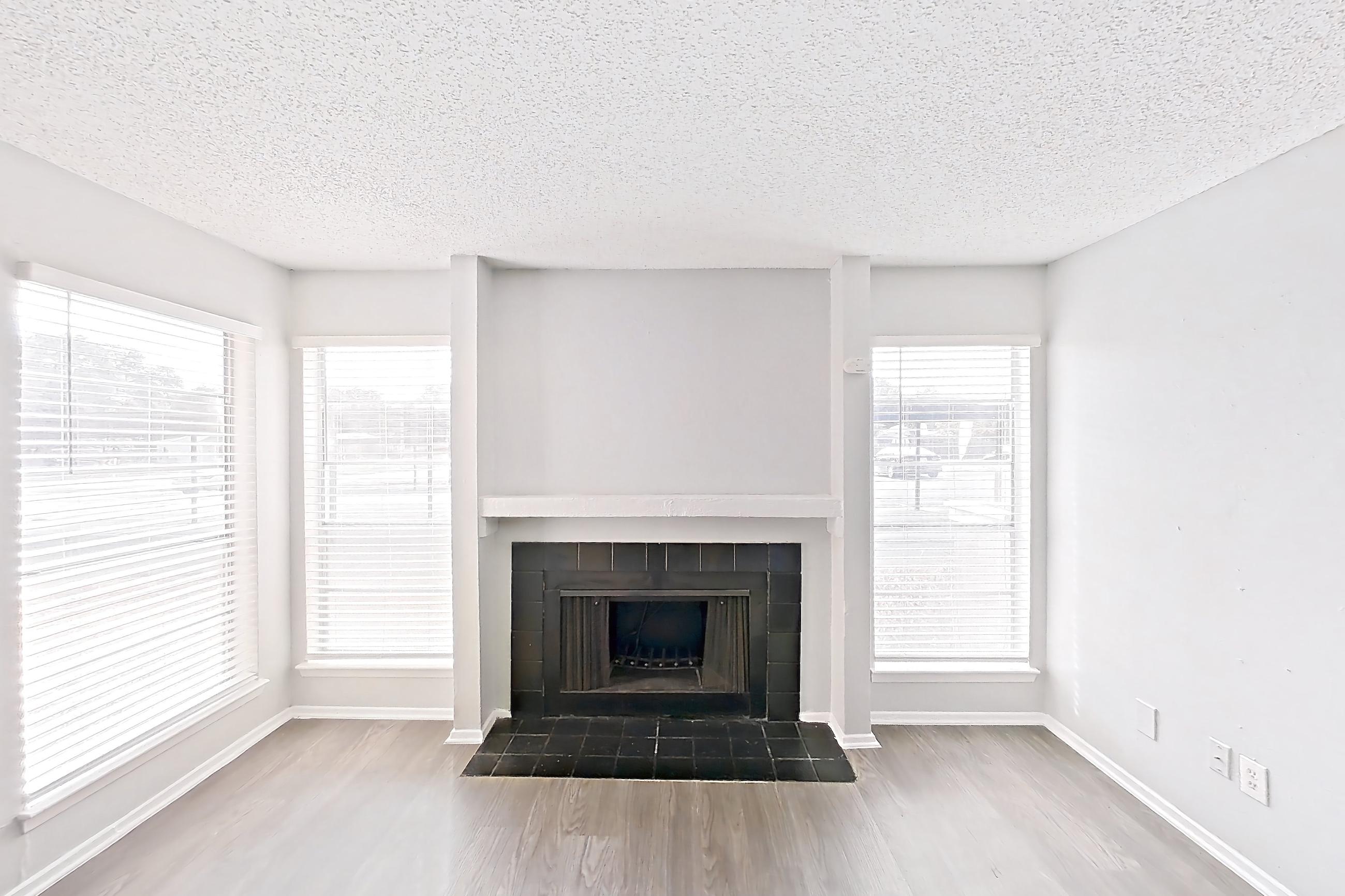 Living room with dark wood-finish flooring, fireplace, and tile fireplace, Apartment 8930SD at The Cassidy at Western Hills