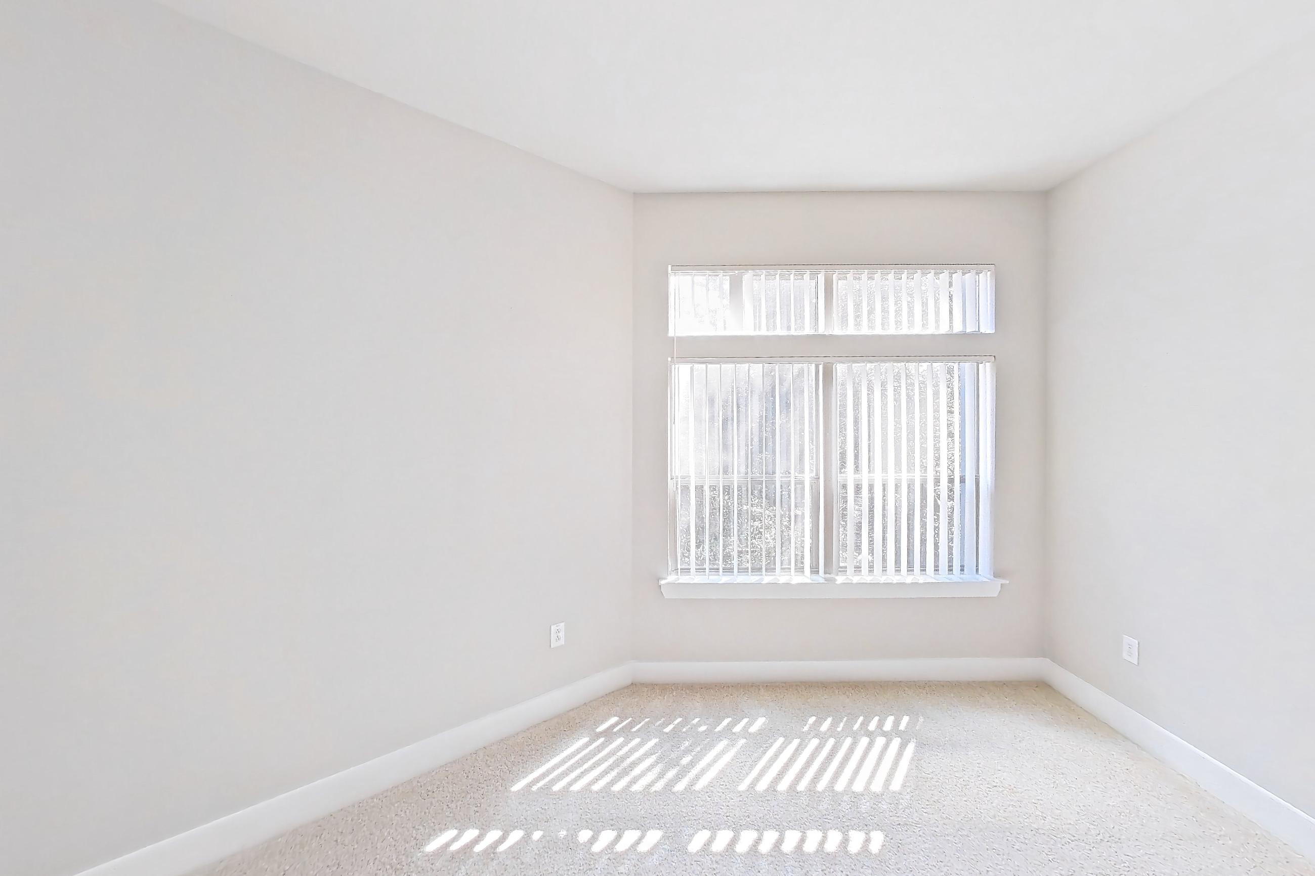 Living room with dark carpet, dishwasher, light carpet, refrigerator, and stainless steel appliances, Apartment 371 at Voyager at the Space Center