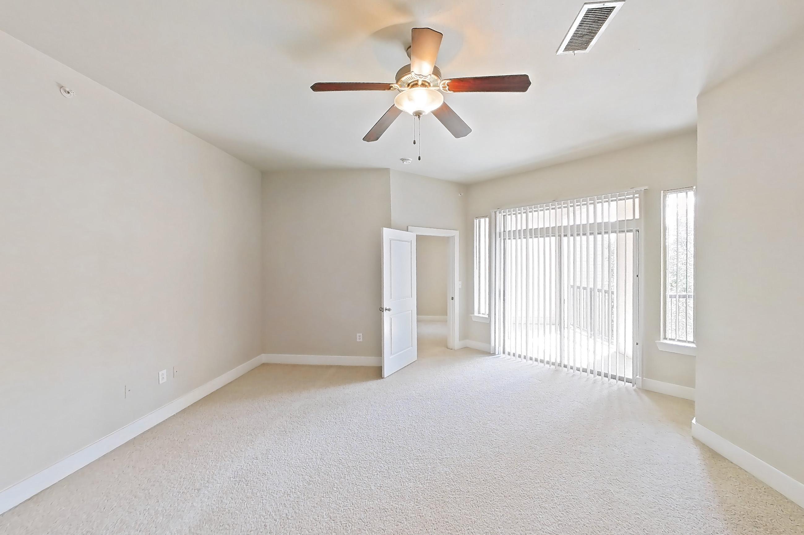 Living space with light carpet, Apartment 444 at Voyager at the Space Center