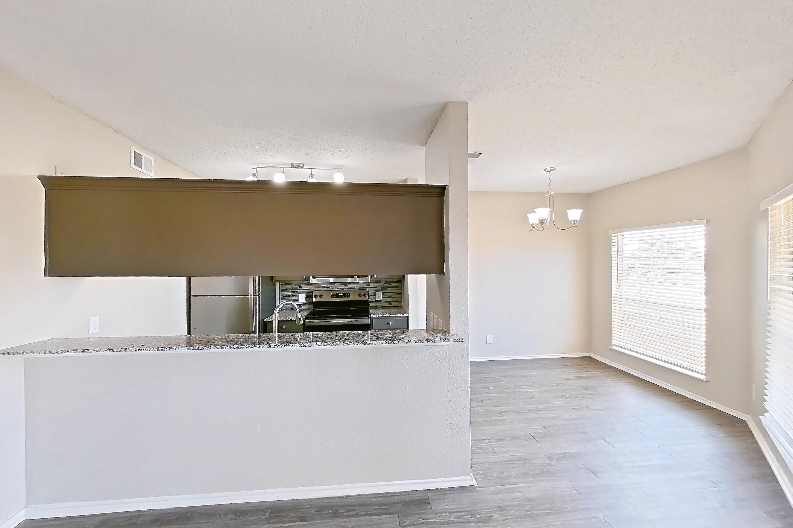 Living room with dark wood-finish flooring, electric range, fireplace, oven/range, refrigerator, stainless steel appliances, and tile fireplace, Apartment 1522 at Waterford on the Meadow