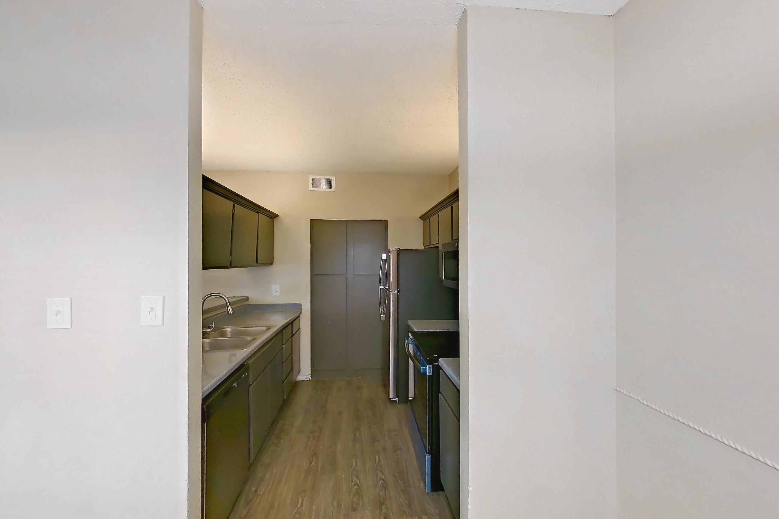 Dining room with black appliances, dark wood-finish flooring, dishwasher, electric range, light countertops, oven/range, refrigerator, and stainless steel appliances, Apartment 3013 at Waterford on the Meadow