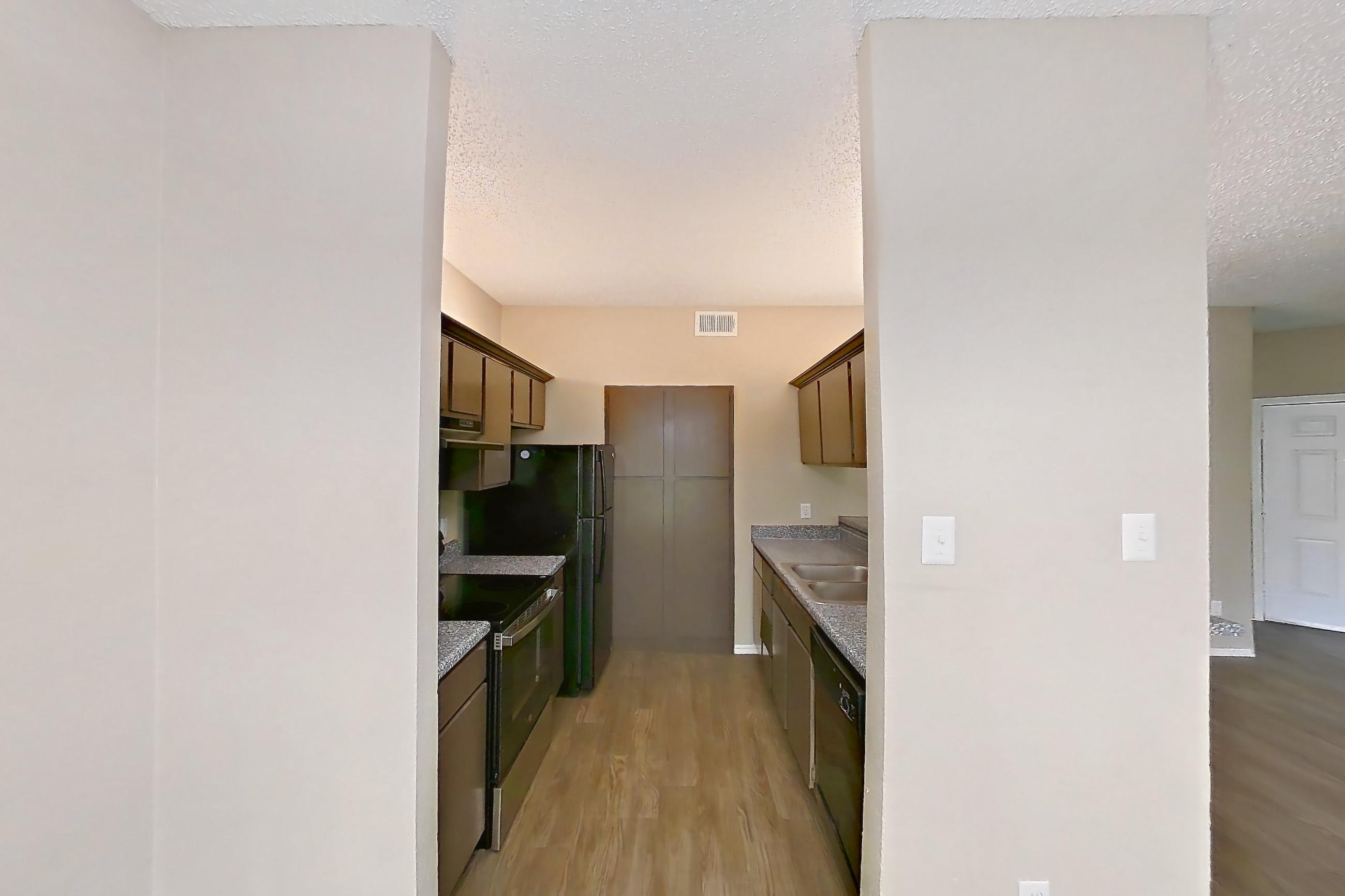 Dining room with dark wood-finish flooring, dishwasher, electric range, light countertops, light wood-finish flooring, oven/range, and stainless steel appliances, Apartment 3122 at Waterford on the Meadow