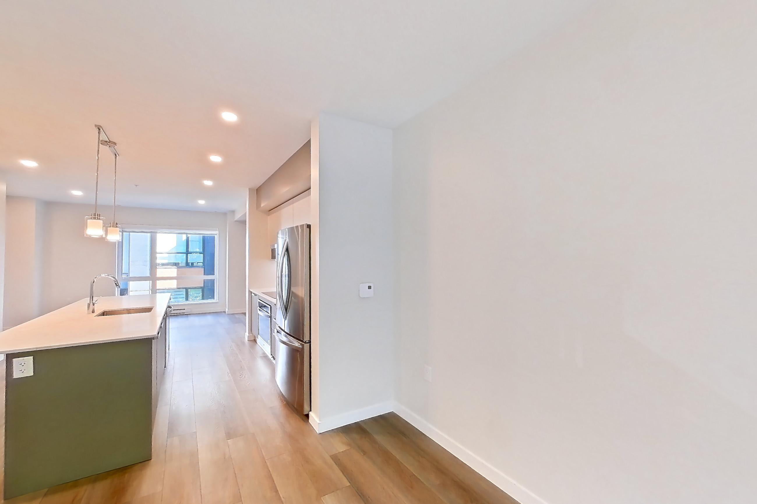 Dining room with baseboard heating, fireplace, light stone countertops, light wood-finish flooring, oven/range, refrigerator, stainless steel appliances, and tile fireplace, Apartment T-074 at Hendry Place