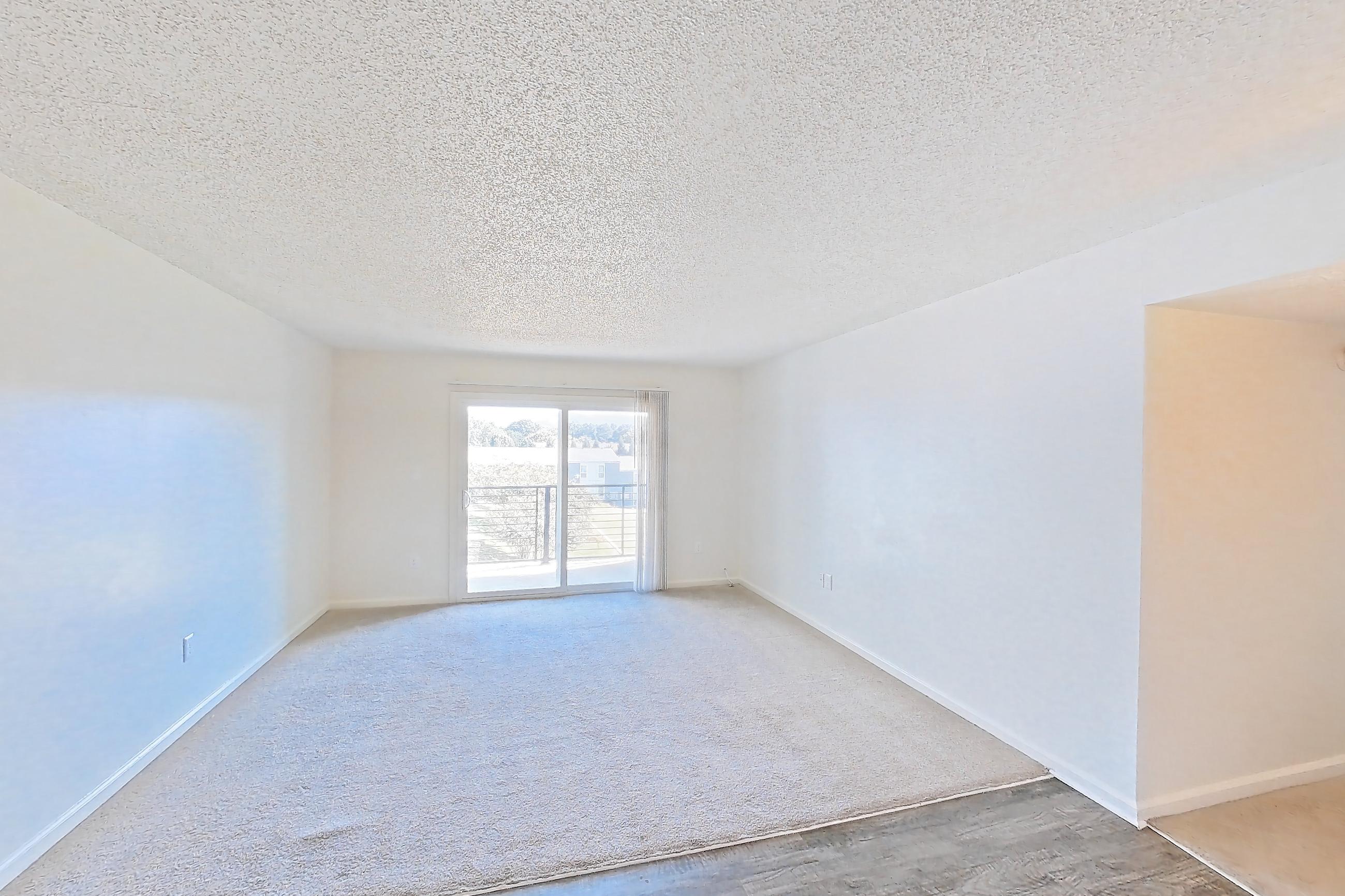 Dining room with dark wood-finish flooring, dishwasher, electric range, light countertops, oven/range, refrigerator, and stainless steel appliances, Apartment 64 at Woodwinds