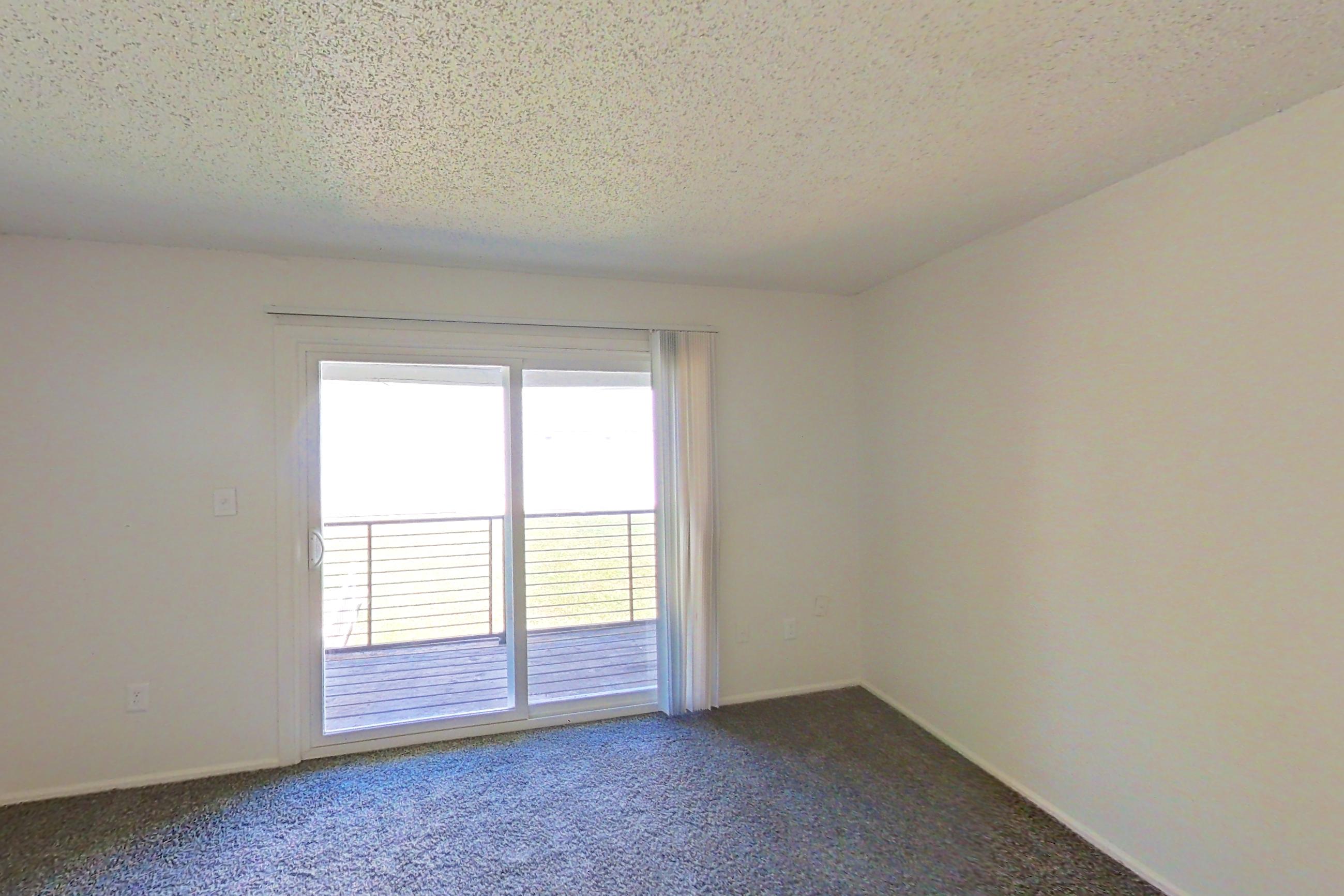 Living space with dark carpet, Apartment 48 at Woodwinds
