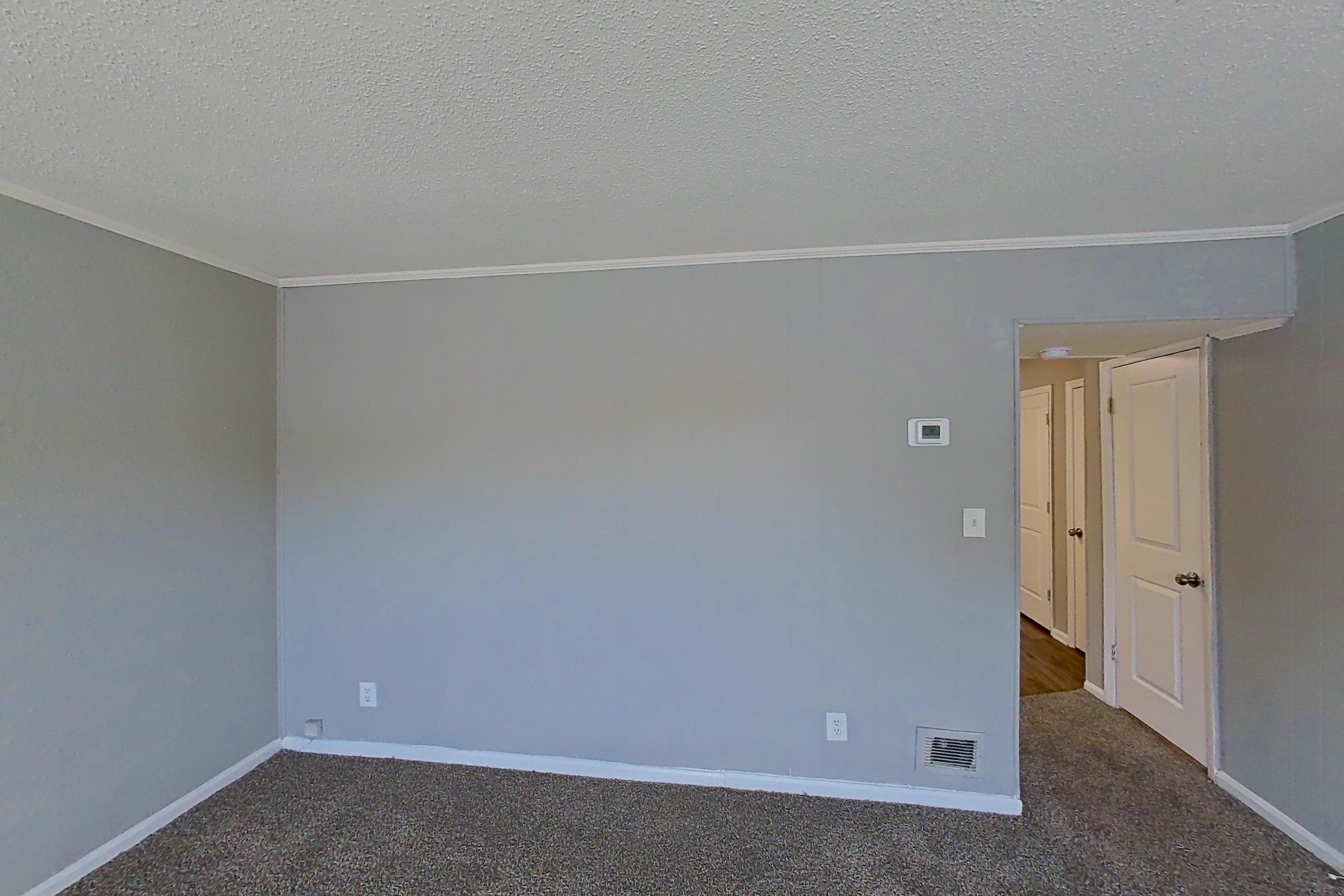 Living room with dark carpet, Apartment 827B at Carriage House & Azalea