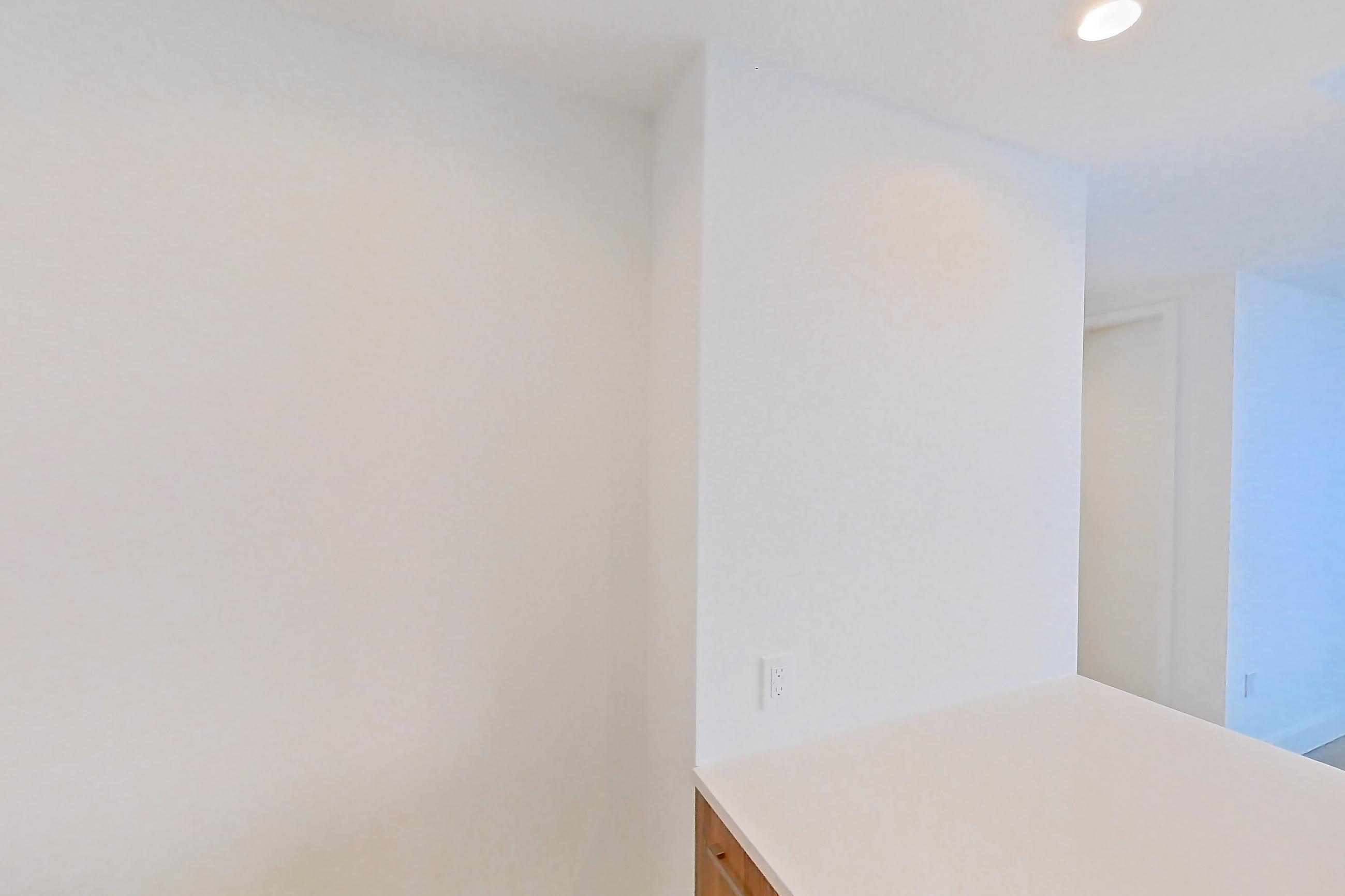 Kitchen with dishwasher, gas range, light countertops, light wood-finish flooring, oven/range, refrigerator, and stainless steel appliances, Apartment 62Q at Lumen