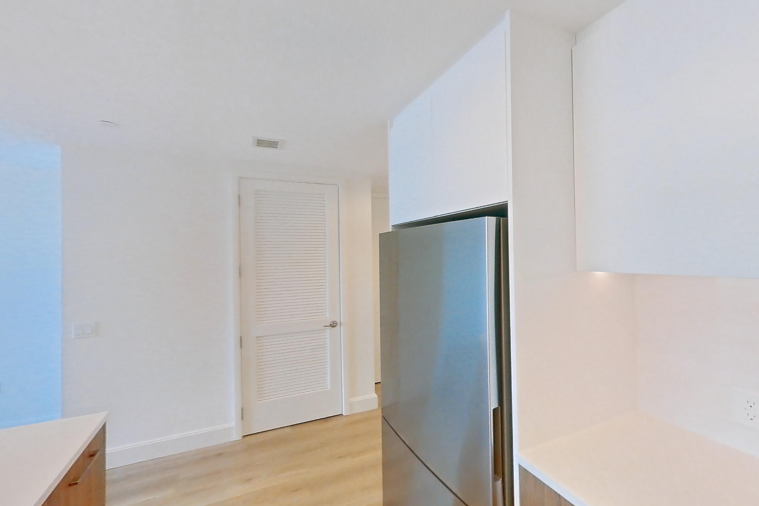 Kitchen with dishwasher, gas range, light countertops, light wood-finish flooring, oven/range, refrigerator, and stainless steel appliances, Apartment 62Q at Lumen