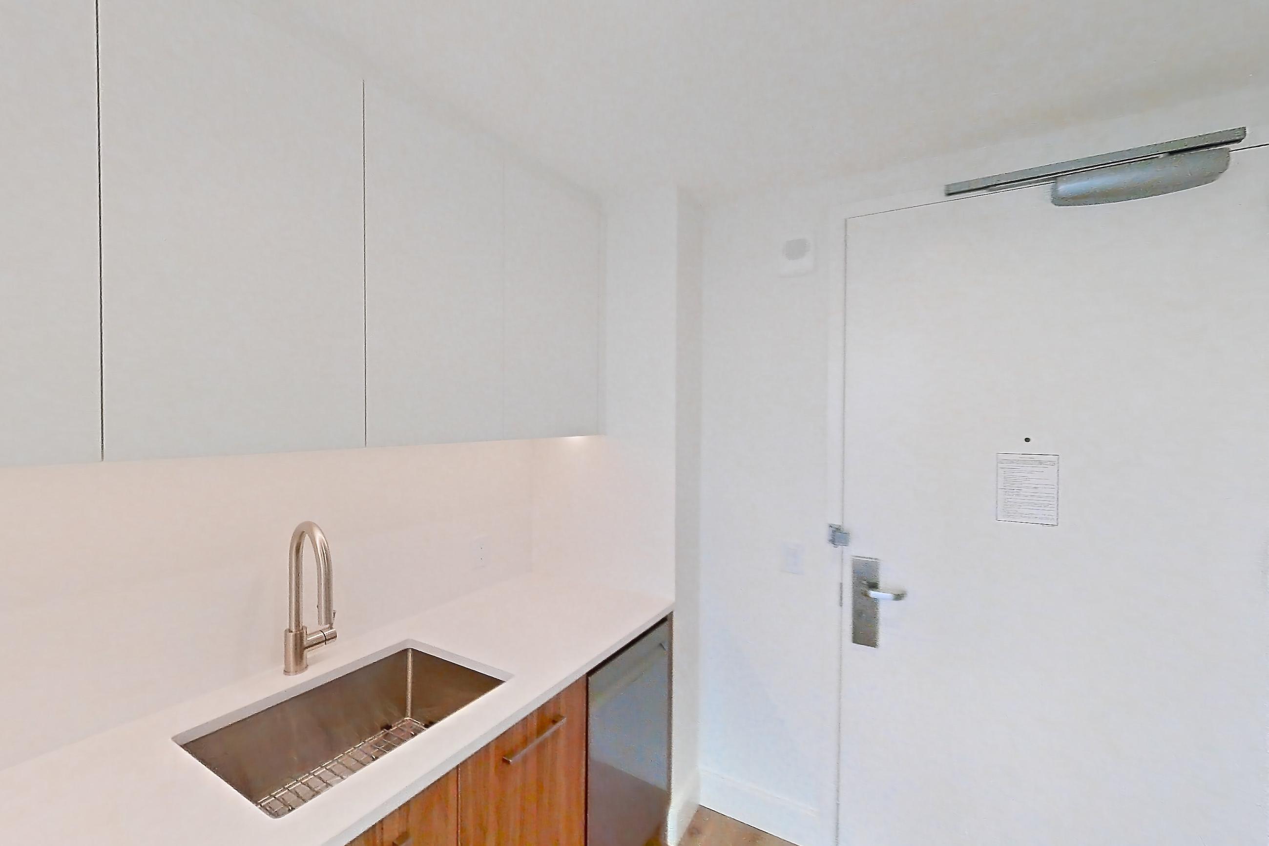 Kitchen with dishwasher, gas range, light countertops, light wood-finish flooring, oven/range, refrigerator, and stainless steel appliances, Apartment 56G at Lumen