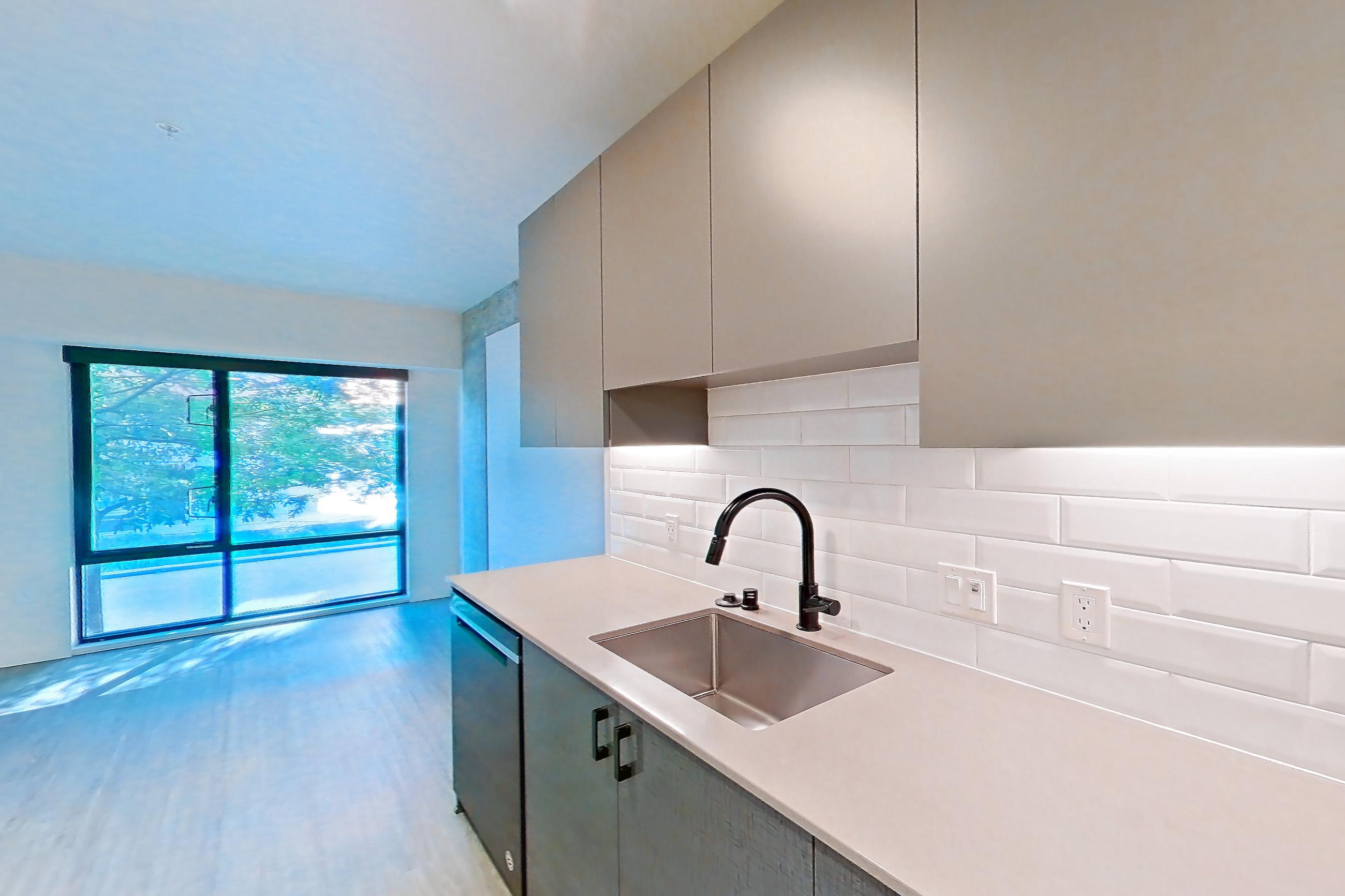 Kitchen in a U1 floor plan unit, representative of Unit 413W at Chroma