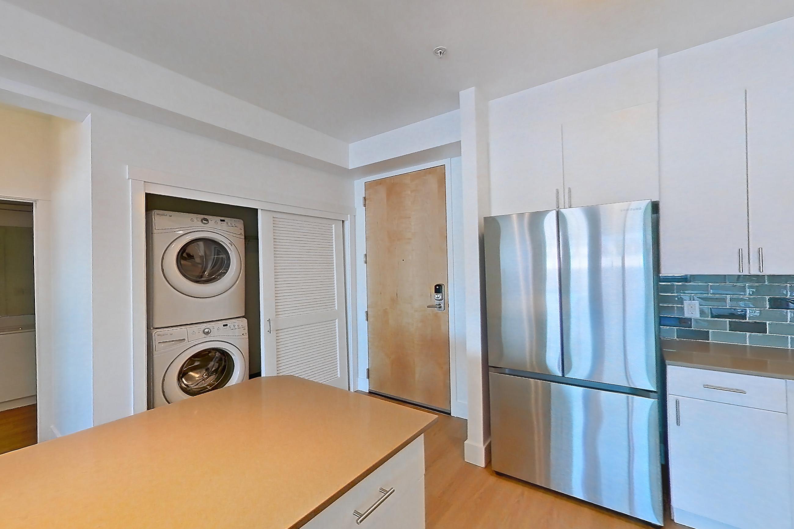 Kitchen with dishwasher, electric range, light countertops, light wood-finish flooring, oven/range, refrigerator, and stainless steel appliances, Unit 826 at The Waymark
