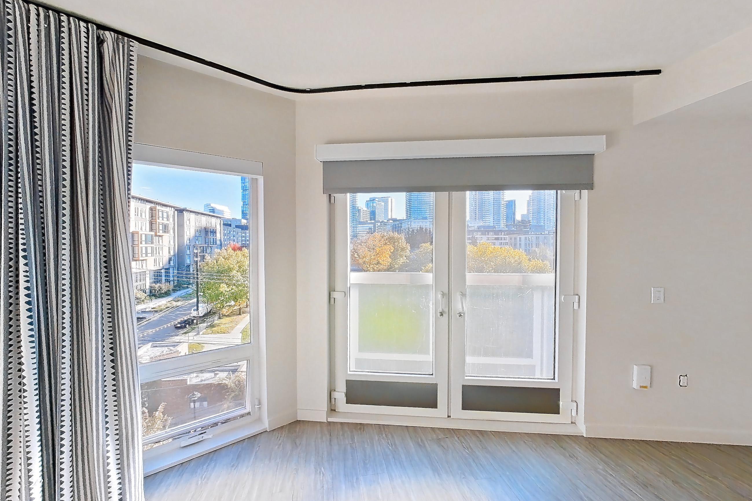 Living space with dishwasher, light wood-finish flooring, and stainless steel appliances, Apartment 515 at Chroma