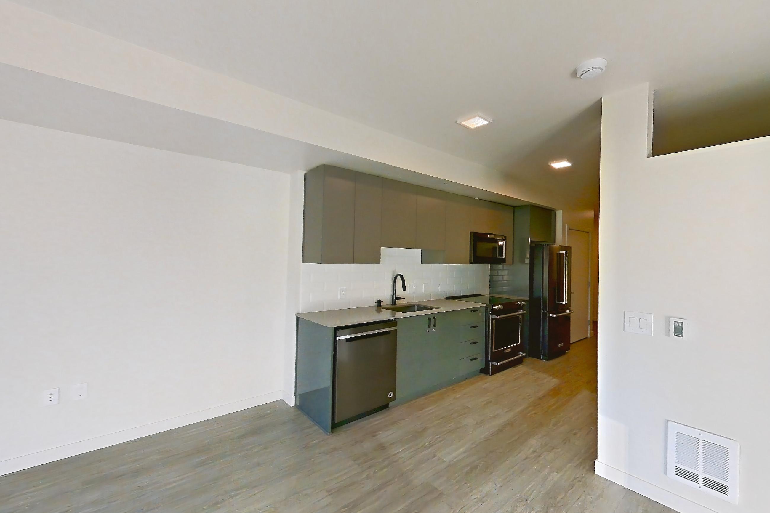 Living space with dishwasher, light wood-finish flooring, and stainless steel appliances, Apartment 515 at Chroma