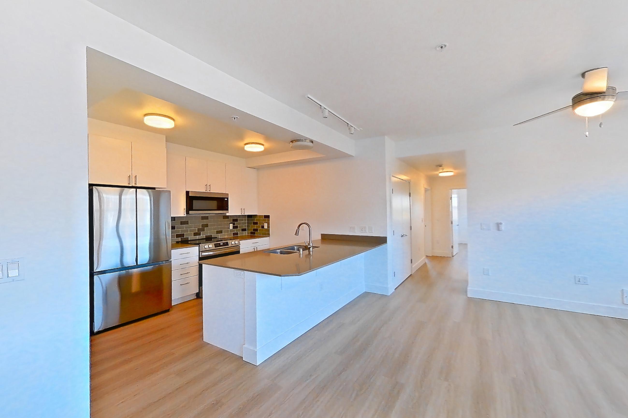 Dining room with dark countertops, light wood-finish flooring, and mini-split AC, Unit 432 at The Waymark