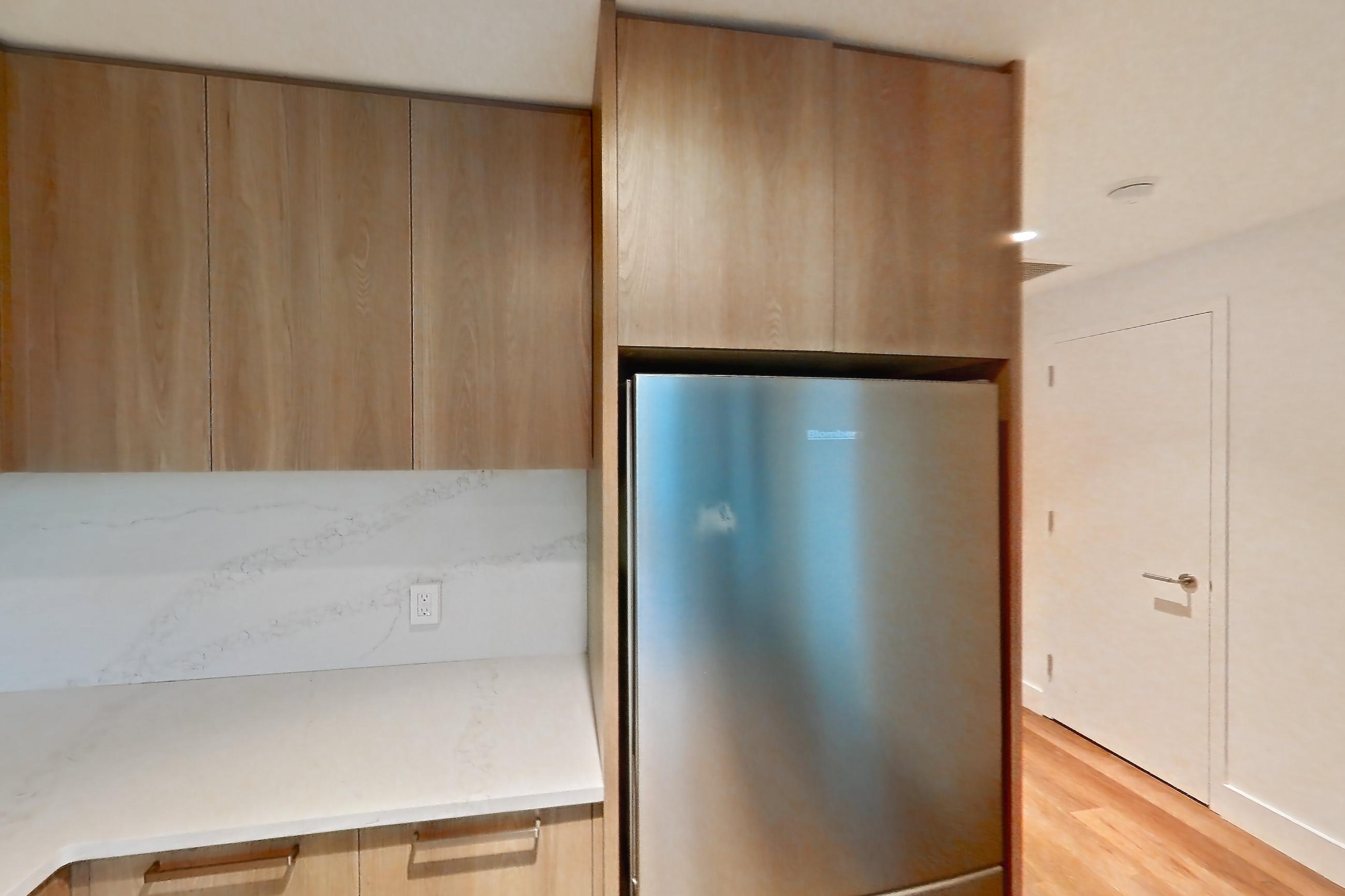 Kitchen with electric range, light countertops, light stone countertops, light wood-finish flooring, oven/range, refrigerator, and stainless steel appliances, Unit 0239 at Hearthstone