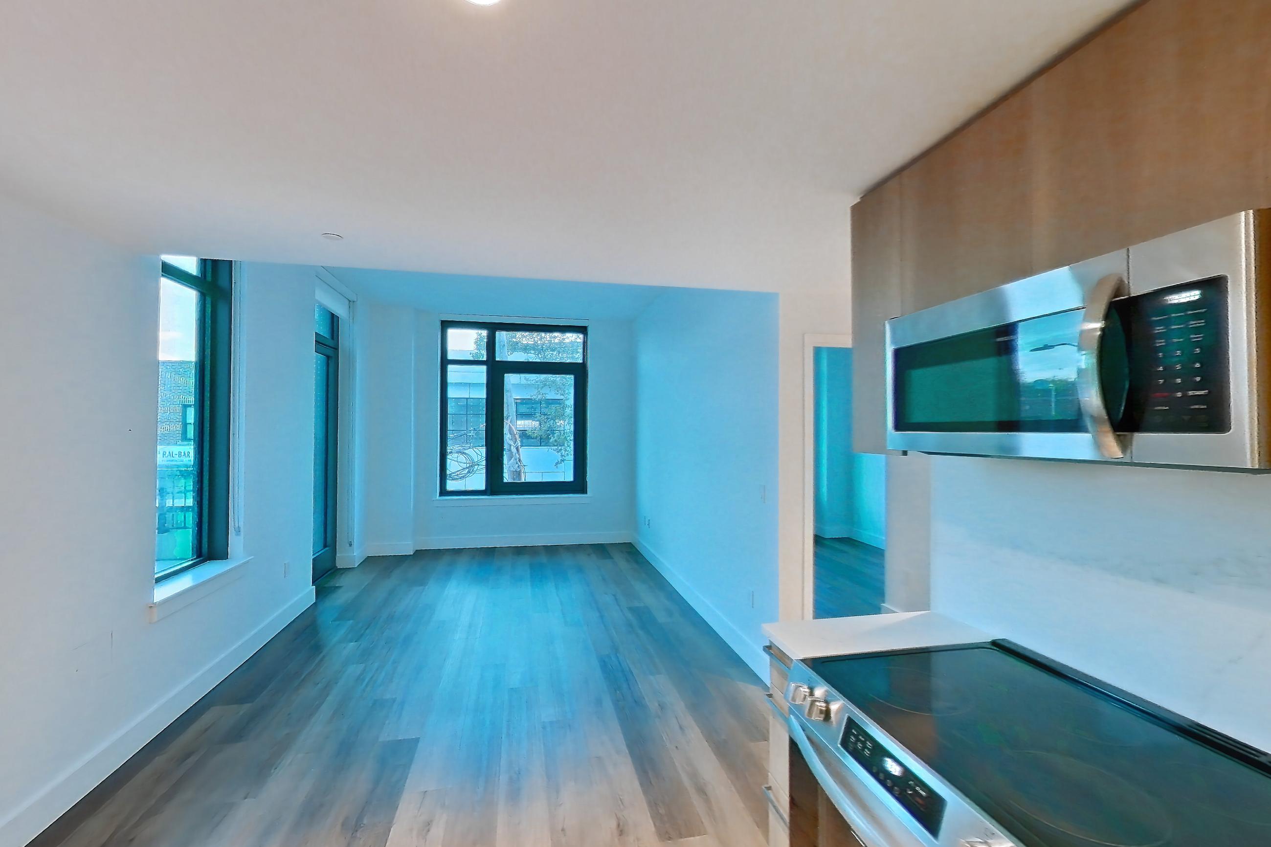 Kitchen with electric range, light countertops, light stone countertops, light wood-finish flooring, oven/range, refrigerator, and stainless steel appliances, Unit 0239 at Hearthstone