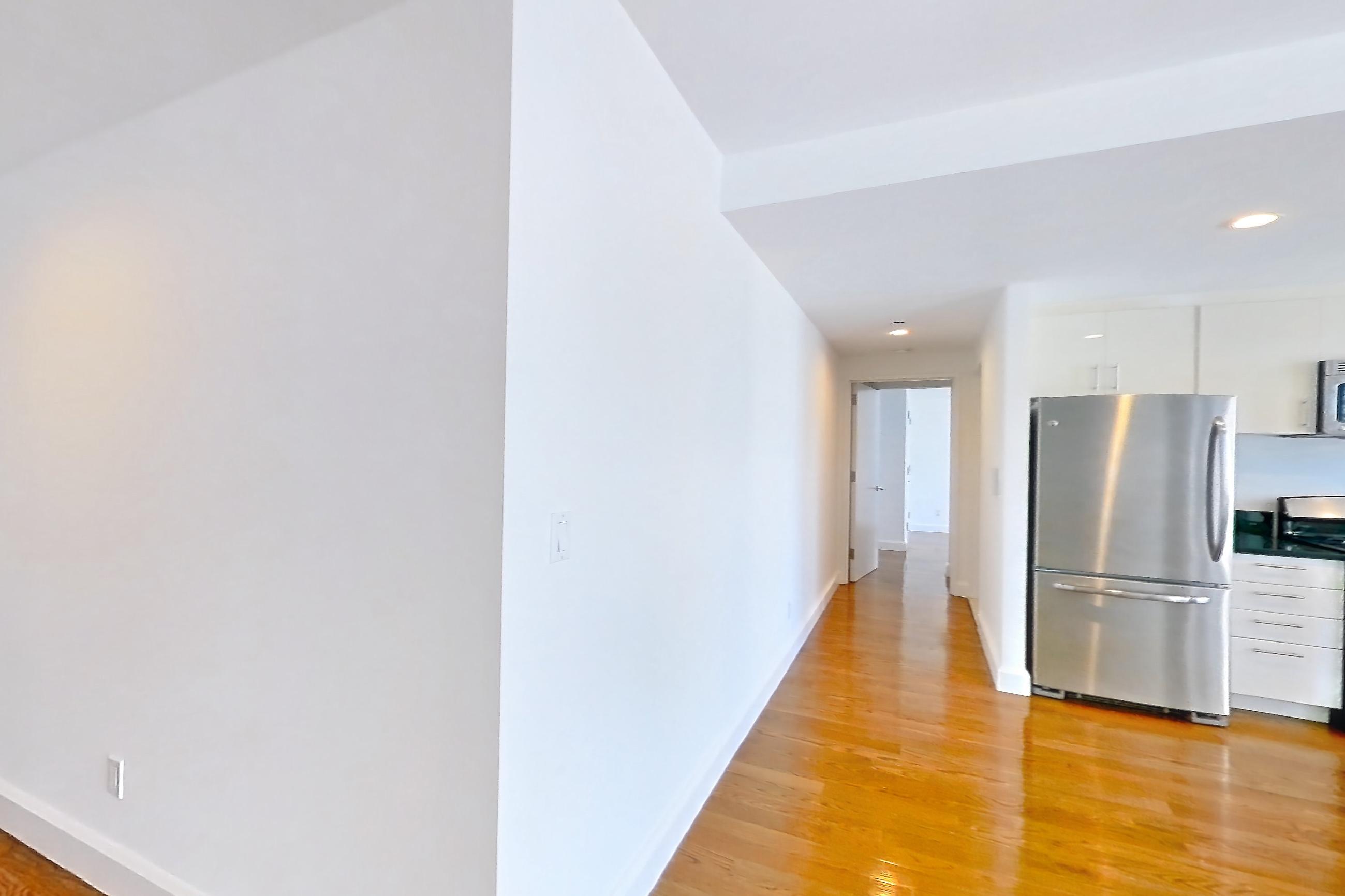 Living space with dark countertops, dishwasher, gas range, light countertops, light wood-finish flooring, microwave, oven/range, refrigerator, and stainless steel appliances, Apartment 18A at The Addison