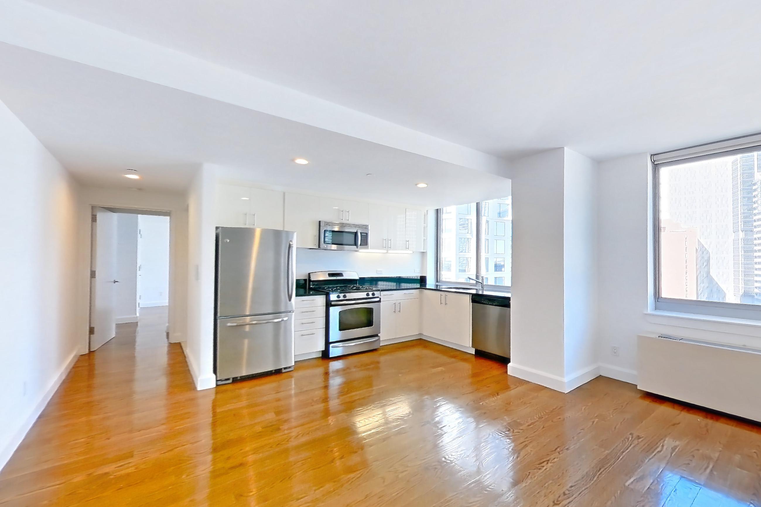 Living space with dark countertops, dishwasher, gas range, light countertops, light wood-finish flooring, microwave, oven/range, refrigerator, and stainless steel appliances, Apartment 18A at The Addison
