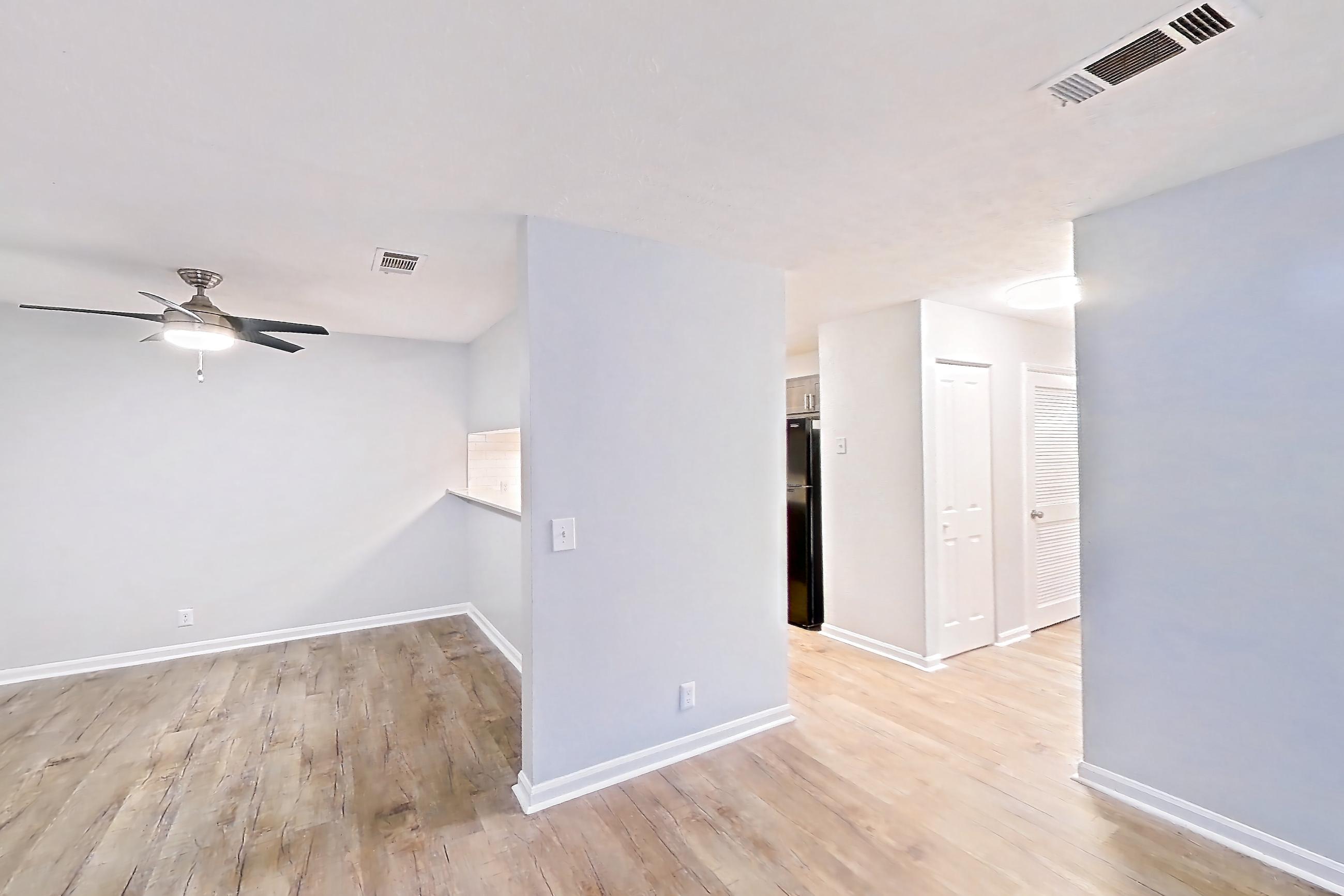 Living room with dark wood-finish flooring, Apartment 10 at The Timbers