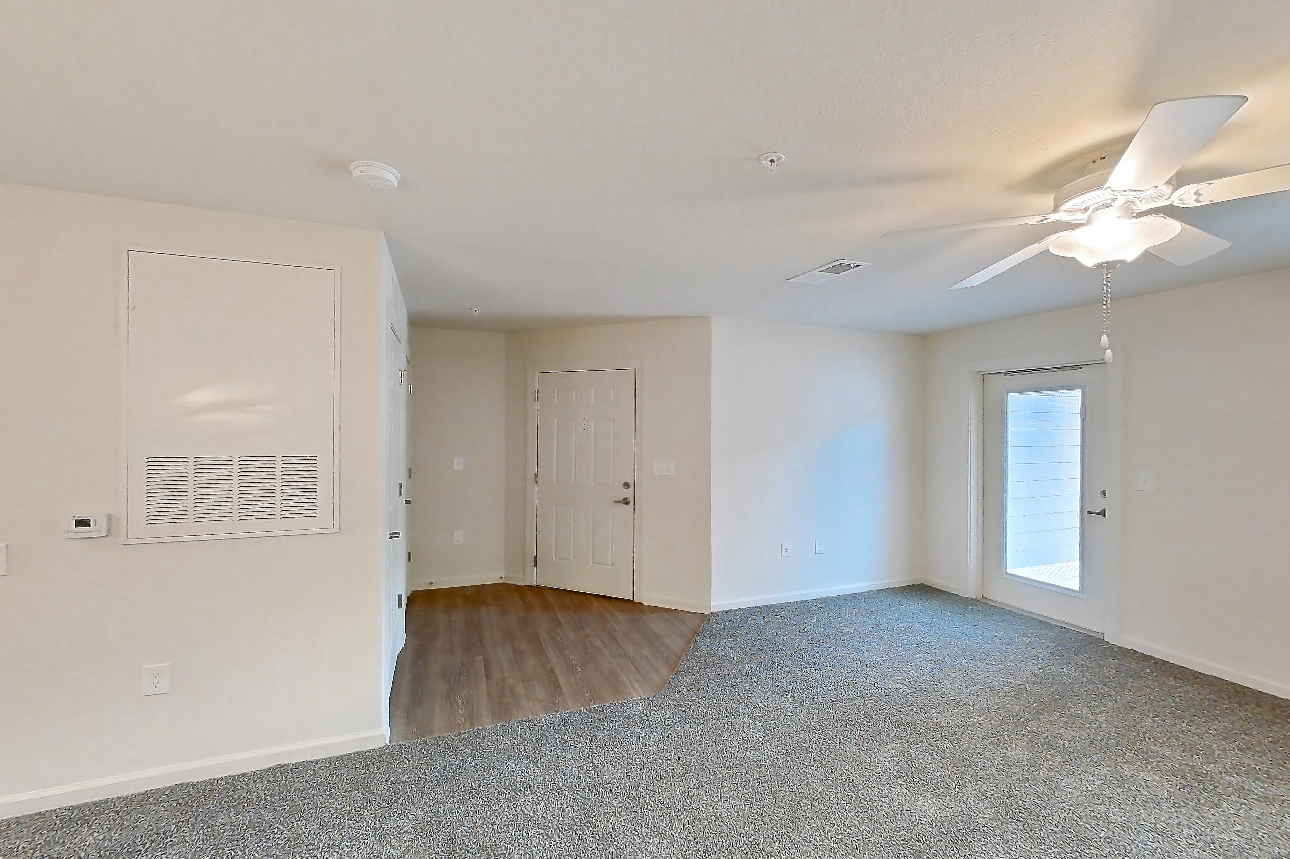 Dining room with black appliances, dark carpet, electric range, light wood-finish flooring, oven/range, and refrigerator, Apartment 10O at Springbrook