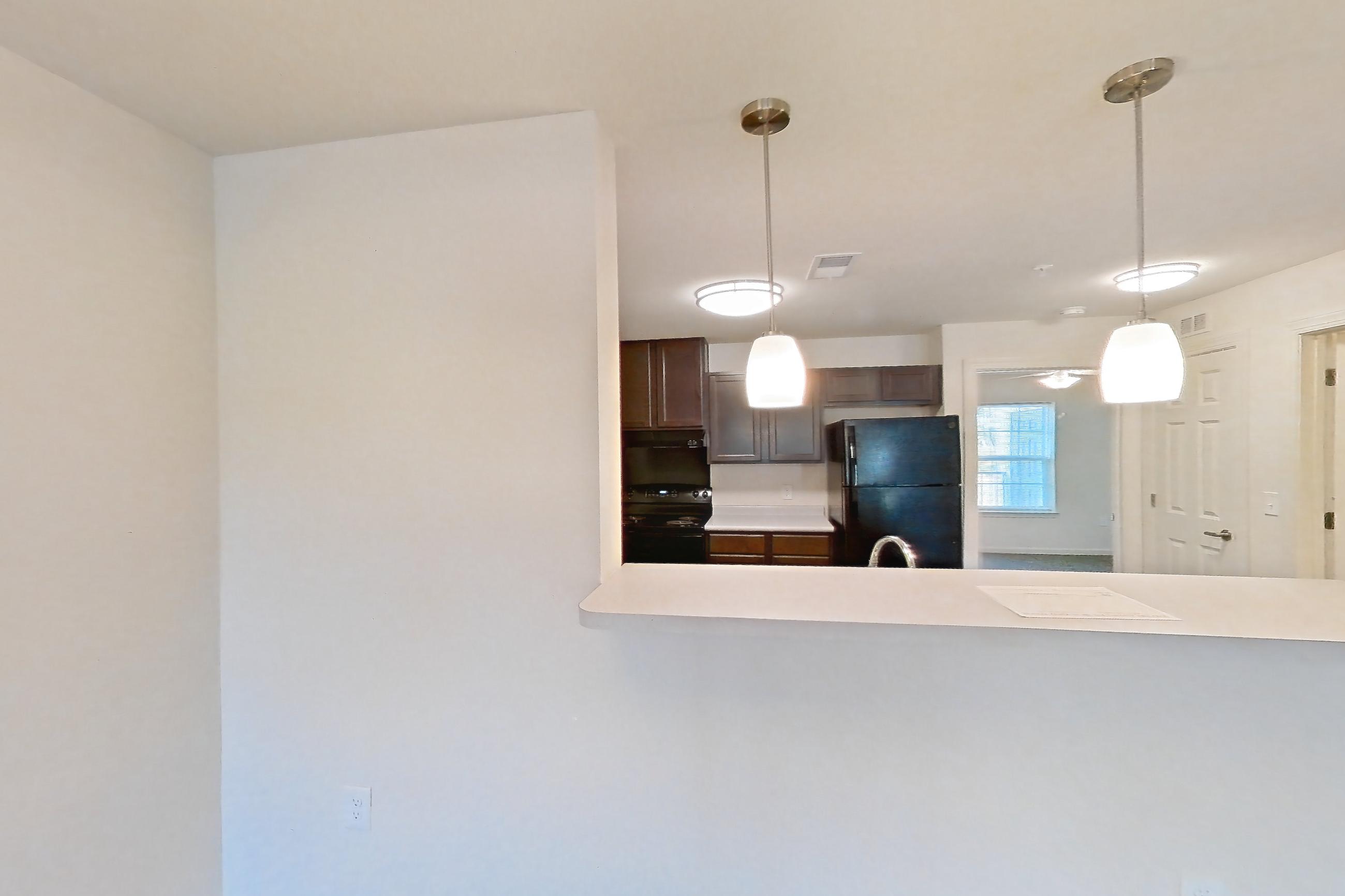 Dining room with black appliances, dark carpet, electric range, light wood-finish flooring, oven/range, and refrigerator, Apartment 10O at Springbrook